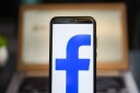 In this photo illustration a Facebook logo seen displayed on a