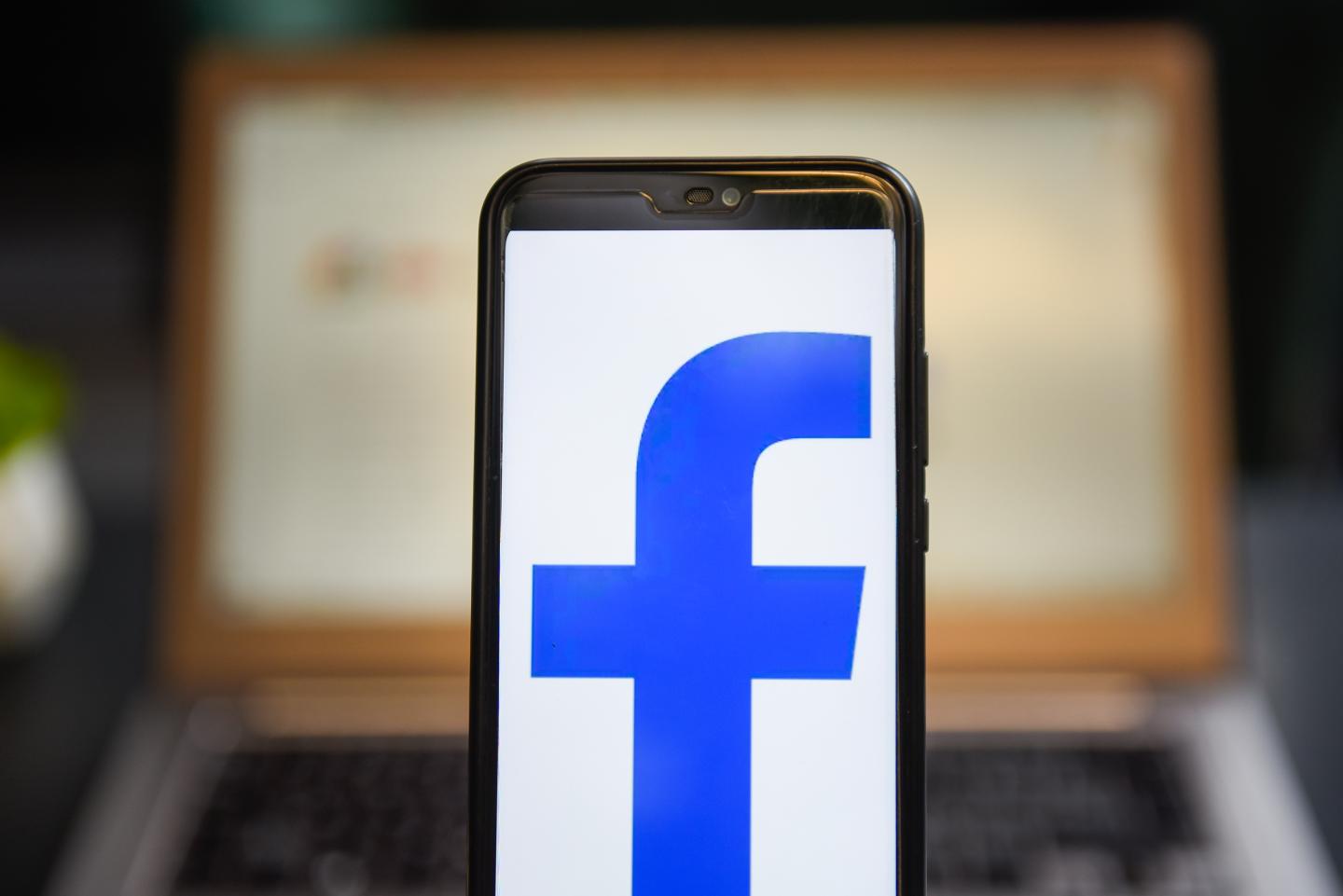 In this photo illustration a Facebook logo seen displayed on a