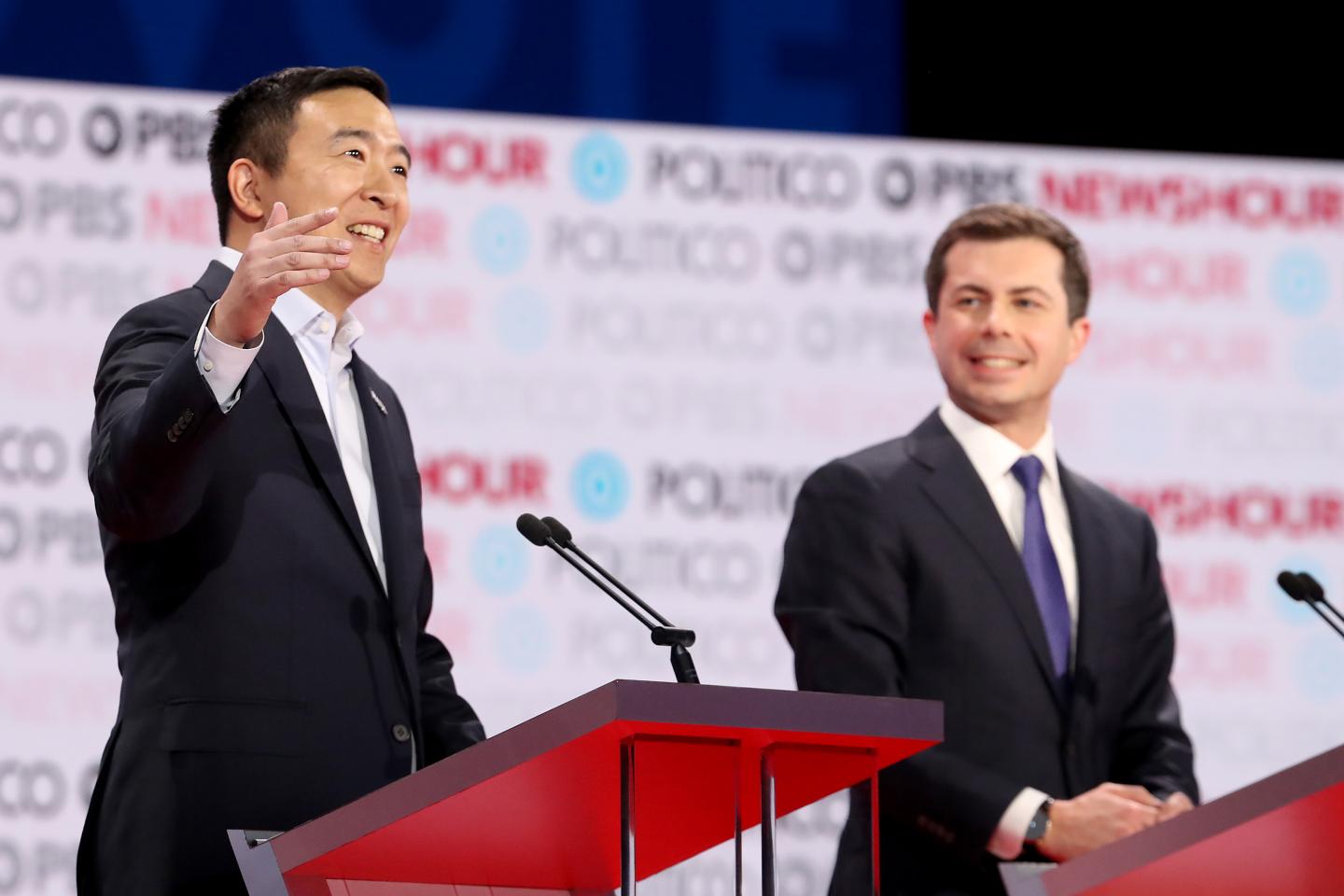 LOS ANGELES, CALIFORNIA - DECEMBER 19: Democratic presidential candidate Andrew Yang (L) speaks as South Bend, Indiana Mayor Pete Buttigieg listens during the Democratic presidential primary debate at Loyola Marymount University on December 19, 2019 in Los Angeles, California. Seven candidates out of the crowded field qualified for the 6th and last Democratic presidential primary debate of 2019 hosted by PBS NewsHour and Politico. (Photo by Justin Sullivan/Getty Images)