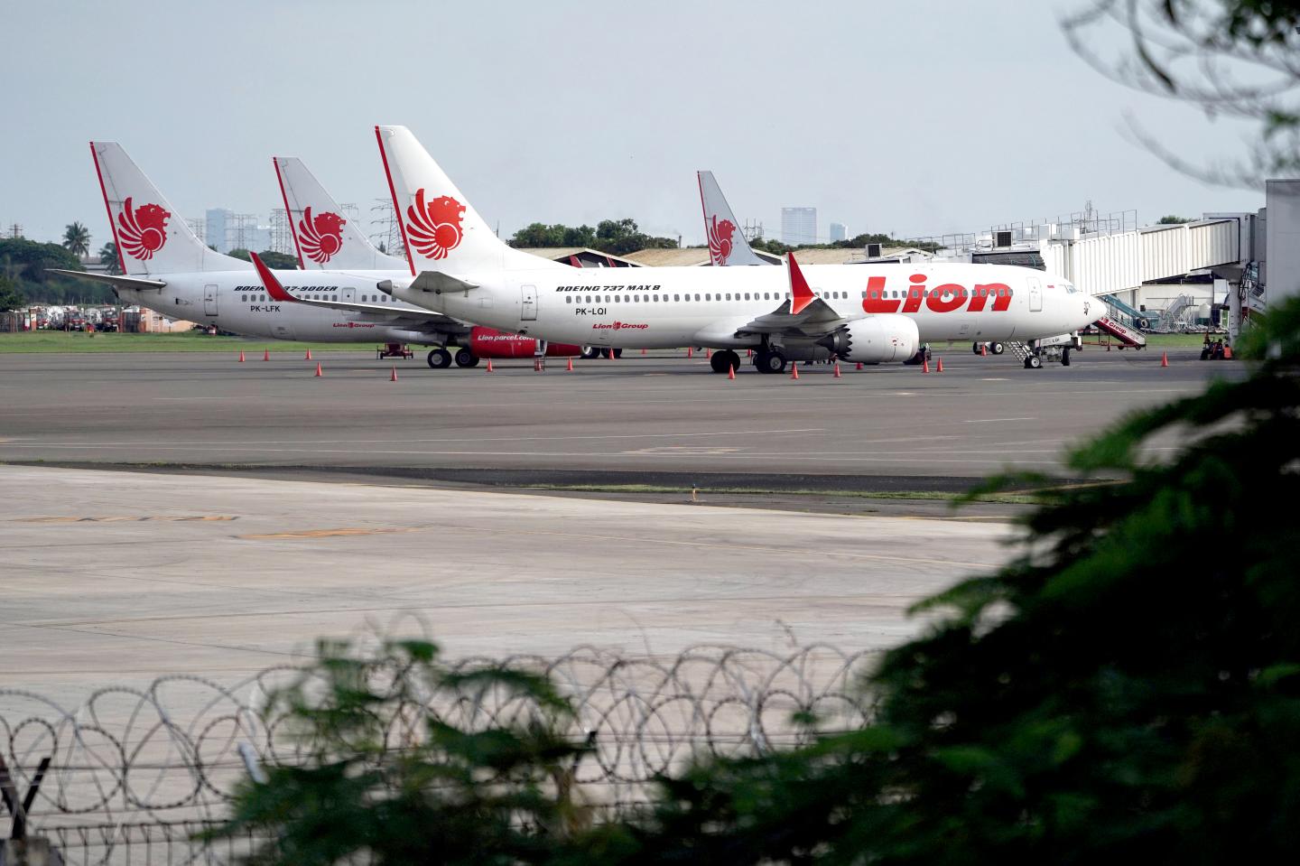 A Lion Air Boeing Co. 737 Max 8 aircraft, right, stands on the tarmac at Soekarno-Hatta International Airport in Cenkareng, Indonesia, on Tuesday, March 12, 2019. Indonesias Lion Air, one of the biggest customers of Boeings 737 Max plane, is suspending delivery of four of the jets it had on order for this year after the second fatal accident involving the model in five months. Photographer: Dimas Ardian/Bloomberg via Getty Images