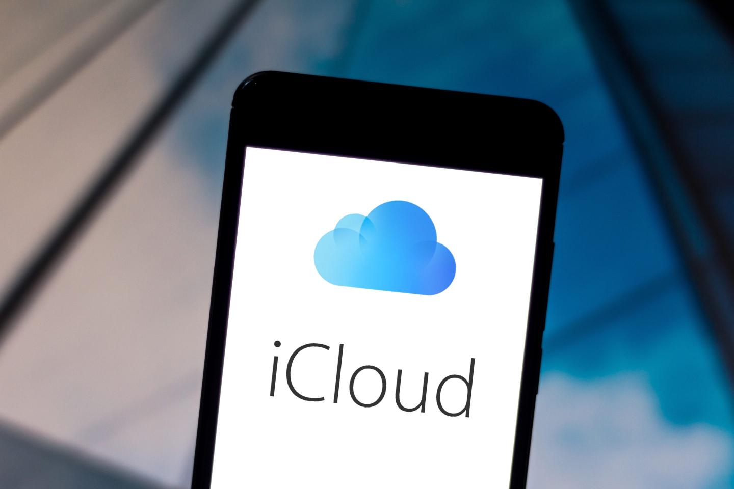 An iCloud logo is displayed on a smartphone