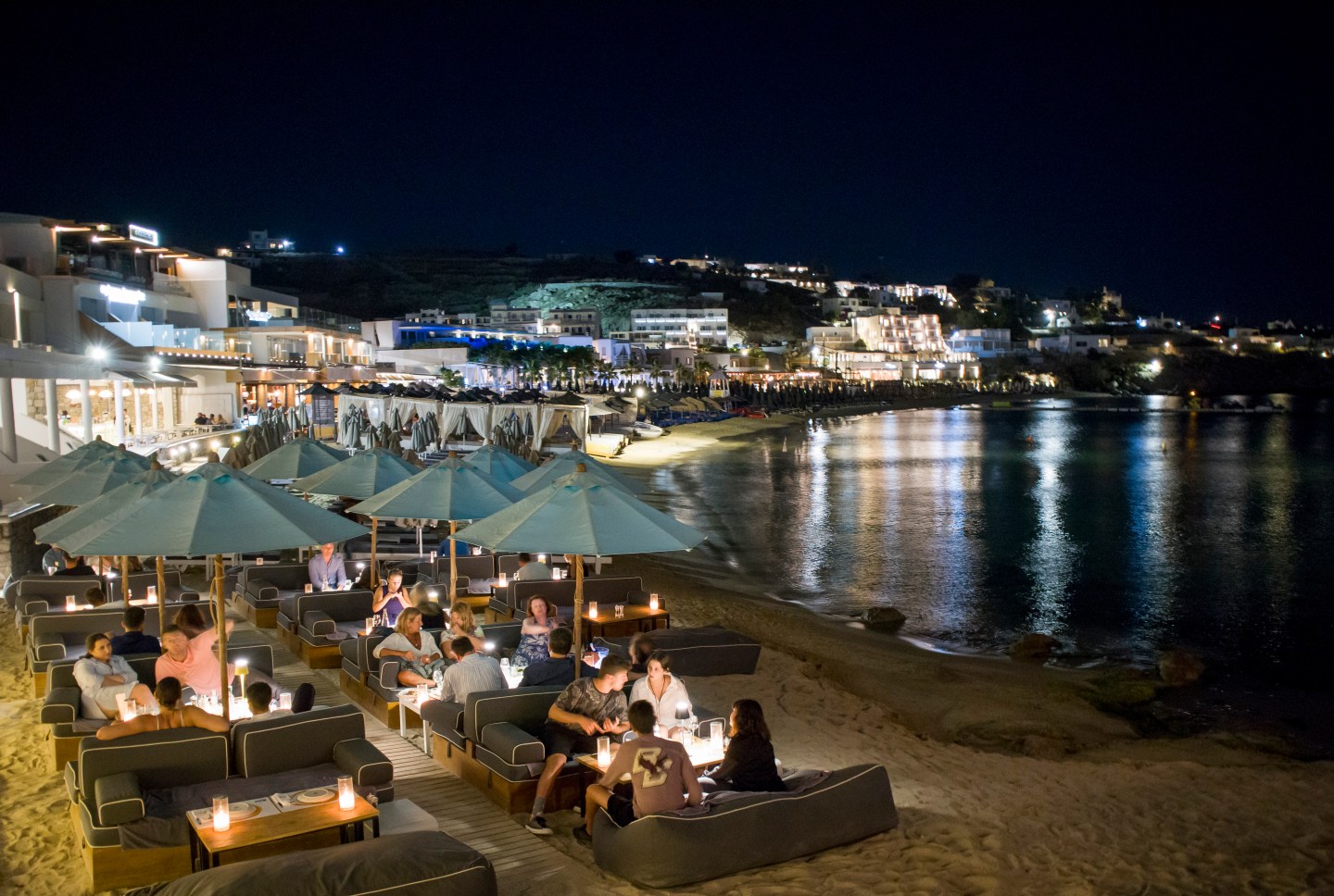 Platis Yialos beach at night in Mykonos, Greece. The island's was recently hooked up to the national power grid on the main land, part of ambitious infrastructure project that's attracted backing from the Chinese. Wire photography: Athanasios Gioumpasis—Getty Images.