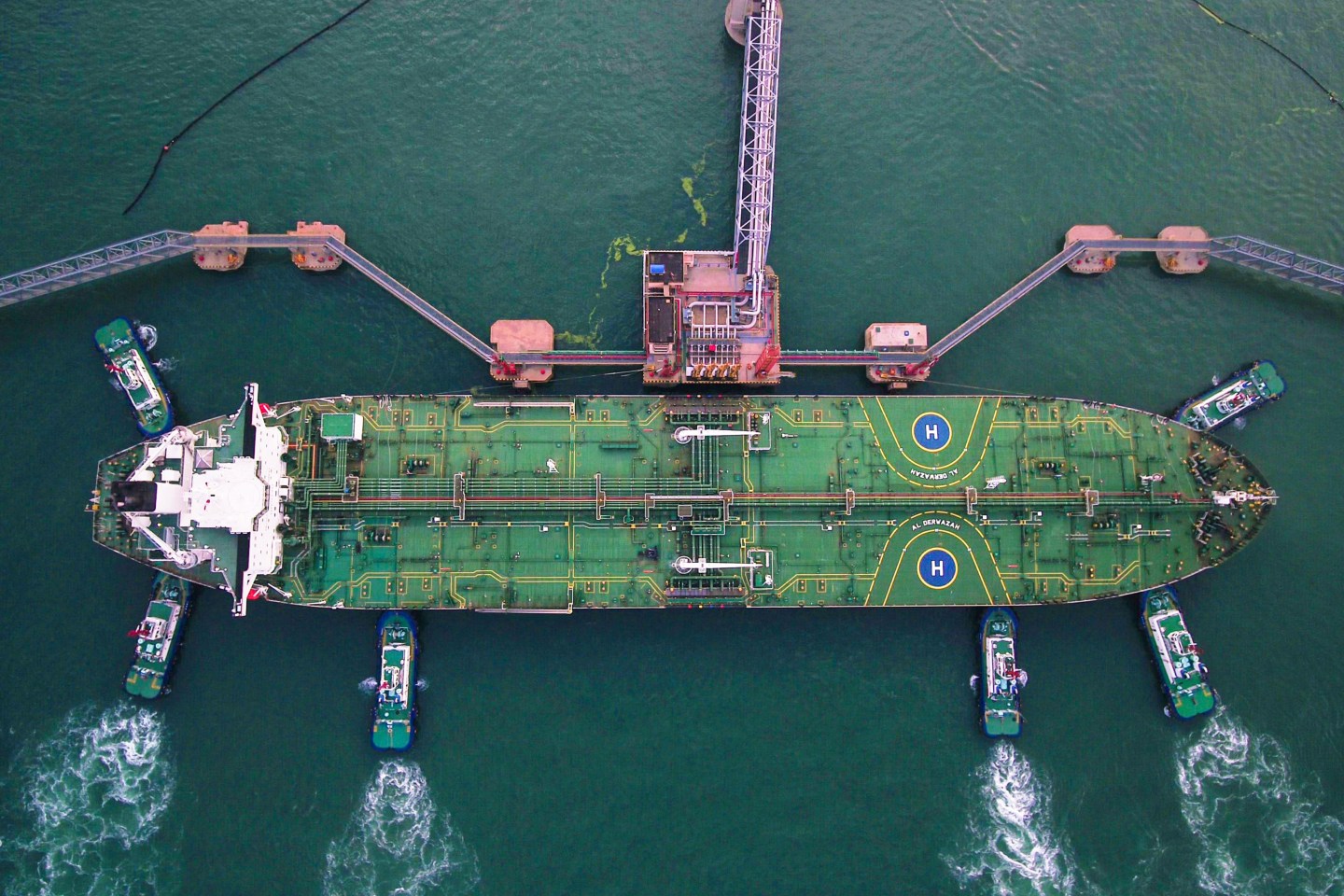 TOPSHOT - This aerial photo taken on August 4, 2019 shows tugboats berthing an oil tanker at Qingdao port in Qingdao in China's eastern Shandong province. - China's good shipments abroad beat expectations to rise in July while its purchases continued to shrink, official data showed on August 8. (Photo by STR / AFP) / China OUT (Photo by STR/AFP via Getty Images)