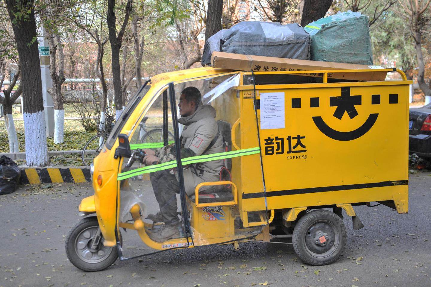 A worker drives a tricycle to deliver packages to customers in Shenyang in China's northeastern Liaoning province on November 14, 2019. (Photo by STR / AFP) / China OUT (Photo by STR/AFP via Getty Images)