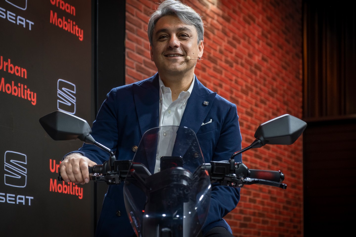 New Renault CEO Luca de Meo presents the SEAT e-scooter motorcycle during an expo in November 2019.