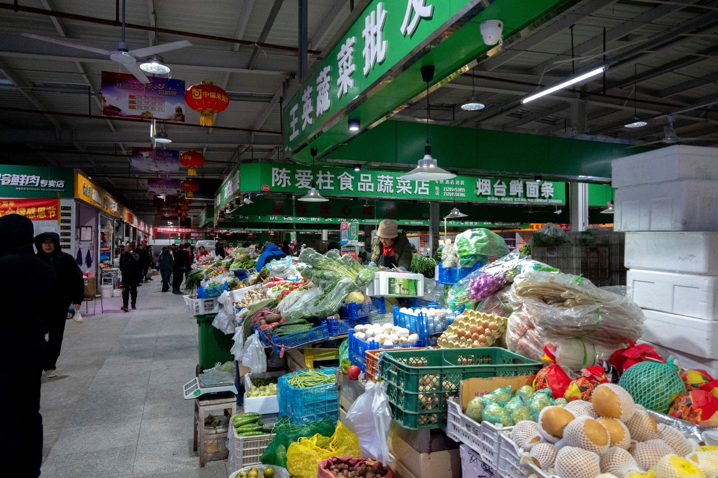 Vegetables stalls in a farm produce market. According to