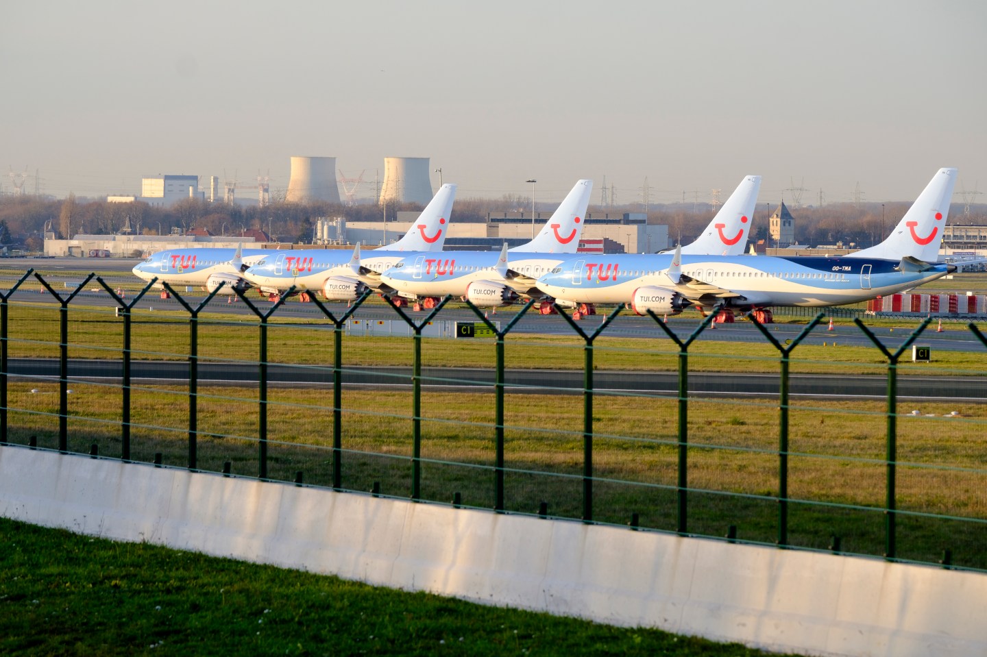 BRUSSELS, BELGIUM - DECEMBER 18: 4 Boeing 737 MAX from TUI fly Belgium are docked in Brussels on December 18, 2019. On December 16, 2019, Boeing announced: 'Safely returning the 737 MAX to service is our top priority. We know that the process of approving the 737 MAX's return to service, and of determining appropriate training requirements, must be extraordinarily thorough and robust, to ensure that our regulators, customers, and the flying public have confidence in the 737 MAX updates. As we have previously said, the FAA and global regulatory authorities determine the timeline for certification and return to service. We remain fully committed to supporting this process. It is our duty to ensure that every requirement is fulfilled, and every question from our regulators answered. Throughout the grounding of the 737 MAX, Boeing has continued to build new airplanes and there are now approximately 400 airplanes in storage. We have previously stated that we would continually evaluate our production plans should the MAX grounding continue longer than we expected. As a result of this ongoing evaluation, we have decided to prioritize the delivery of stored aircraft and temporarily suspend production on the 737 program beginning next month.' Created in 2004 under the name of TUI Airlines Belgium, it took over, after the bankruptcy of Sobelair, which until then had been the main airline of the tour operator Jetair, to transport Belgian tourists to their destination. On October 19, 2016, Jetairfly and the other companies in the TUI group were renamed TUI Airlines to bring together the different brands of the group under the same name. (Photo by Thierry Monasse/Getty Images)