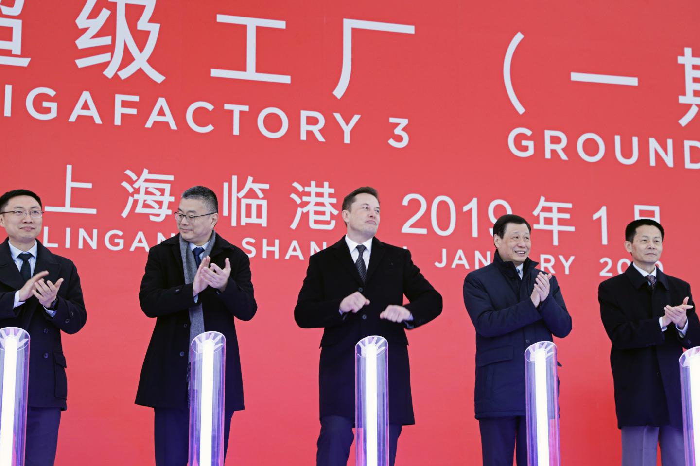 Elon Musk, chief executive officer of Tesla Inc., center, reacts as Robin Ren, vice president of sales, second left, Ying Yong, mayor of Shanghai, second right, and Wu Qing, vice mayor of Shanghai, right, applaud during an event at the site of the company's manufacturing facility in Shanghai, China, on Monday, Jan. 7, 2019. This tumultuous year in enterprise saw the rise of big companies and the fall of top executives. Throughout, politics loomed large over business as US President Donald Trump's America and trade-war-buffeted China. In Russia, one of the country's longest-standing American investors found that past good relations are no guarantee of the future and WeWorks fall from grace became one of the biggest business stories of the year. Photographer: Qilai Shen/Bloomberg via Getty Images