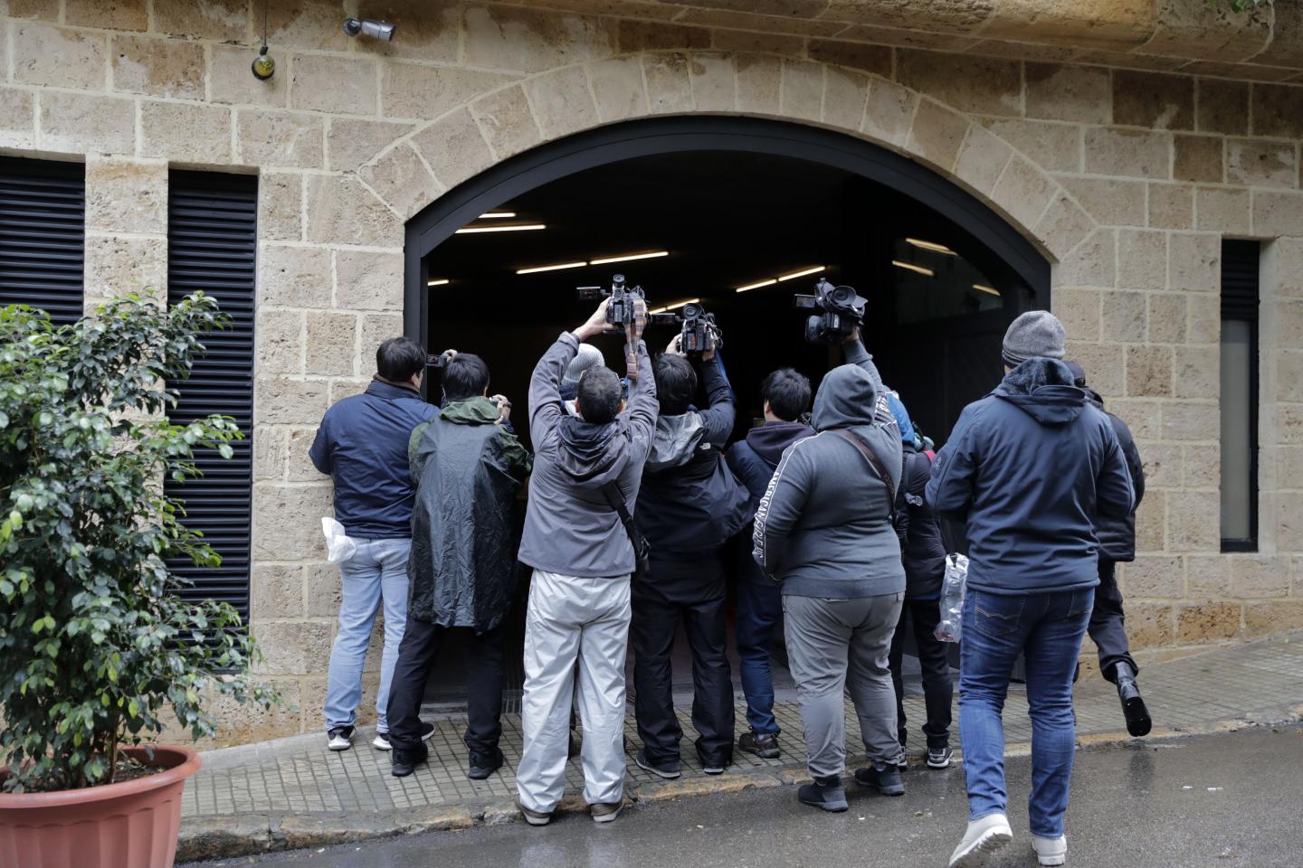 Journalists gather at the entrance of the underground parking of a house said to belong to former Nissan chief Carlos Ghosn in a wealthy neighbourhood of the Lebanese capital Beirut on January 4, 2020. - Former Renault-Nissan boss Carlos Ghosn, who skipped bail in Japan and fled to Beirut, is due to be summoned by Lebanon's public prosecutor next week, an official said. Ghosn, once Japan's best paid corporate executive, was arrested in November 2018 and has been under house arrest since April, facing multiple charges of financial misconduct. (Photo by Anwar AMRO / AFP) (Photo by ANWAR AMRO/AFP via Getty Images)
