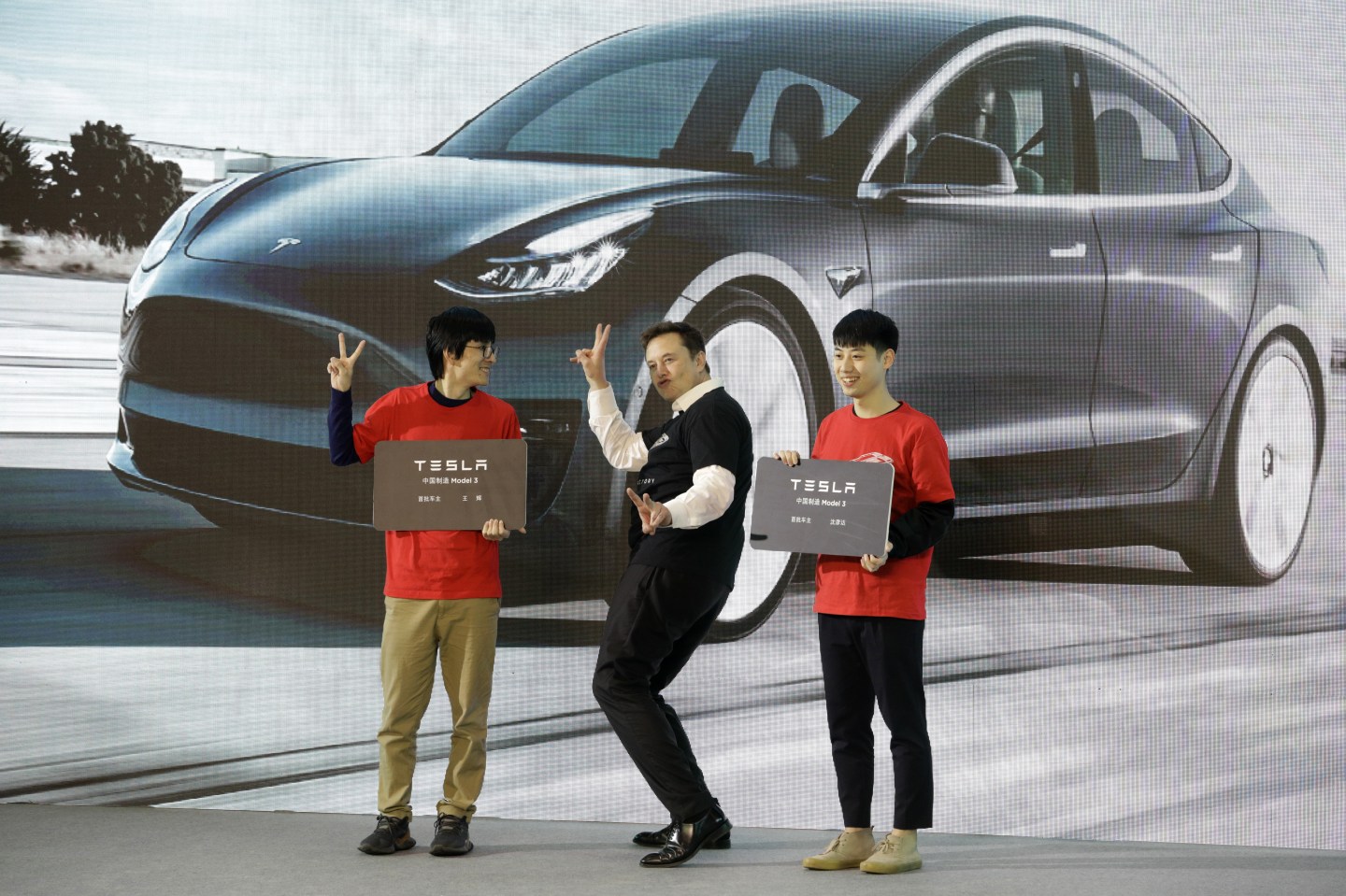 Elon Musk, chief executive officer of Tesla Inc., gestures during the Tesla China-Made Model 3 Delivery Ceremony at the company's Gigafactory in Shanghai, China, on Tuesday, Jan. 7, 2020. Tesla kicked off production in China, marking a major step in Musks global push for electric-vehicle domination and heralding what could be the dawn of real competition in the worlds largest EV market. Photographer: Qilai Shen/Bloomberg via Getty Images