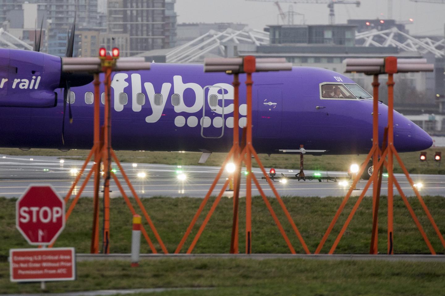 A passenger aircraft, operated by Flybe Group Plc, taxis past landing lights at London City Airport in London, U.K., on Tuesday, Jan. 14, 2020. U.K. regional airline Flybe has only days to secure a rescue package that could include help from the government, according to a person with knowledge of the talks. Photographer: Chris Ratcliffe/Bloomberg via Getty Images