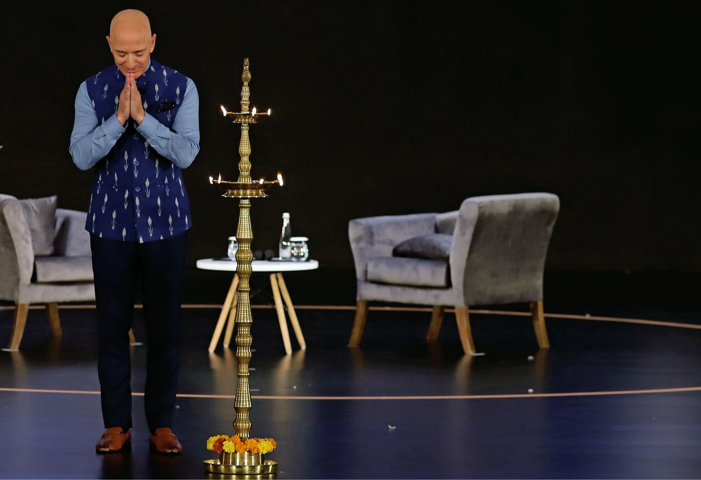 Jeff Bezos, founder and chief executive officer of Amazon.com Inc., gestures next to a diya stand during the opening session of Amazon Sambhav event in New Delhi, India, on Wednesday, Jan. 15, 2020. Bezos got a bitter reception during his India visit this week after the country's antitrust regulator initiated a formal investigation hours before his arrival and infuriated small store owners demonstrated in the streets. Photographer: Anindito Mukherjee/Bloomberg via Getty Images