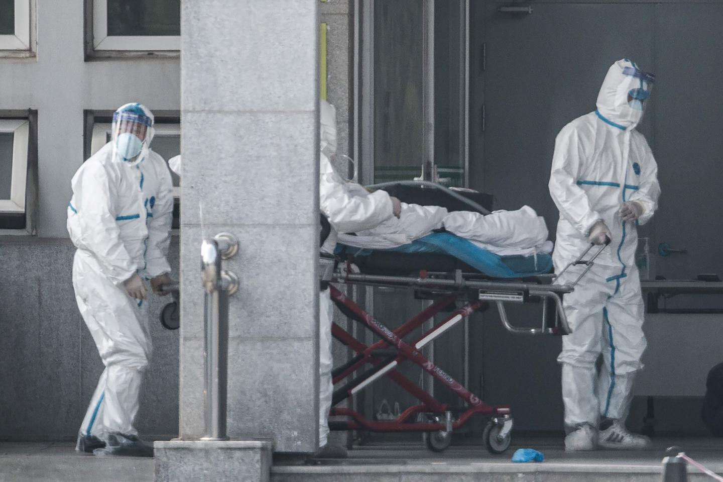 Medical staff members carry a patient into the Jinyintan hospital, where patients infected by a mysterious SARS-like virus are being treated, in Wuhan in China's central Hubei province on January 18, 2020. (Photo by STR / AFP) / China OUT (Photo by STR/AFP via Getty Images)