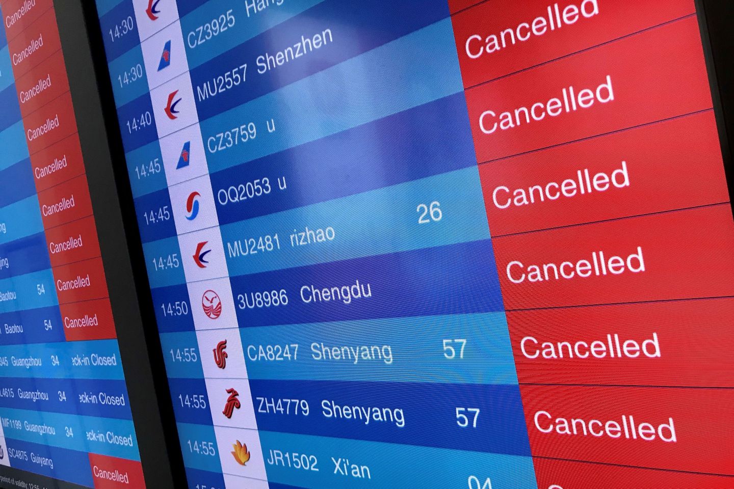 A screen shows cancelled flights is pictured at Tianhe airport in Wuhan in China's central Hubei province on January 23, 2020. - China banned trains and planes from leaving a major city at the centre of a virus outbreak on January 23, seeking to seal off its 11 million people to contain the contagious disease that has claimed 17 lives, infected hundreds and spread to other countries. (Photo by Leo RAMIREZ / AFP) (Photo by LEO RAMIREZ/AFP via Getty Images)
