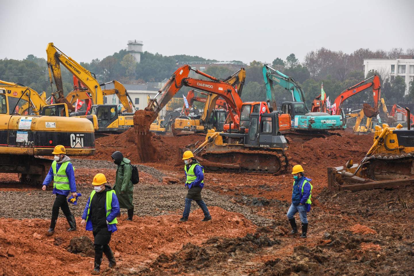Employees work at a construction site of a hospital to treat patients during a virus outbreak in Wuhan in China's central Hubei province on January 24, 2020. - China is rushing to build a new hospital in a staggering 10 days to treat patients at the epicentre of a deadly virus outbreak that has stricken hundreds of people, state media reported on January 24. (Photo by STR / AFP) / China OUT (Photo by STR/AFP via Getty Images)