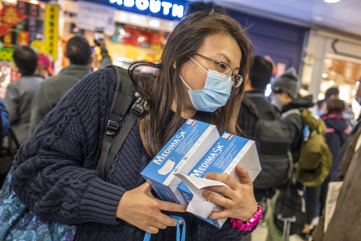 A woman holds boxes of newly purchased protective masks at a shopping mall in Hong Kong, China, on Wednesday, Jan. 29, 2020. Governments tightened international travel and border crossings with China as they ramped up efforts to stop the spread of the disease. Photographer: Justin Chin/Bloomberg via Getty Images