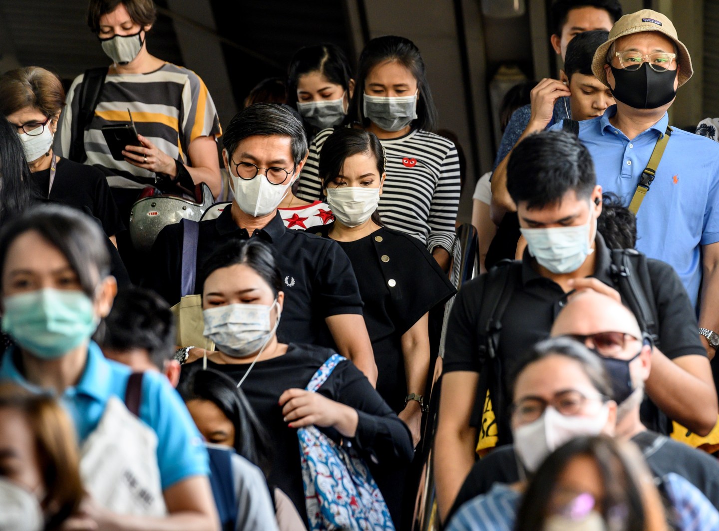 People wearing protective facemasks leave the city commuter train station in Bangkok on January 31, 2020. - The World Health Organization declared a global emergency over the new coronavirus, as China reported on January 31 the death toll had climbed to 213 with nearly 10,000 infections. (Photo by Mladen ANTONOV / AFP) (Photo by MLADEN ANTONOV/AFP via Getty Images)