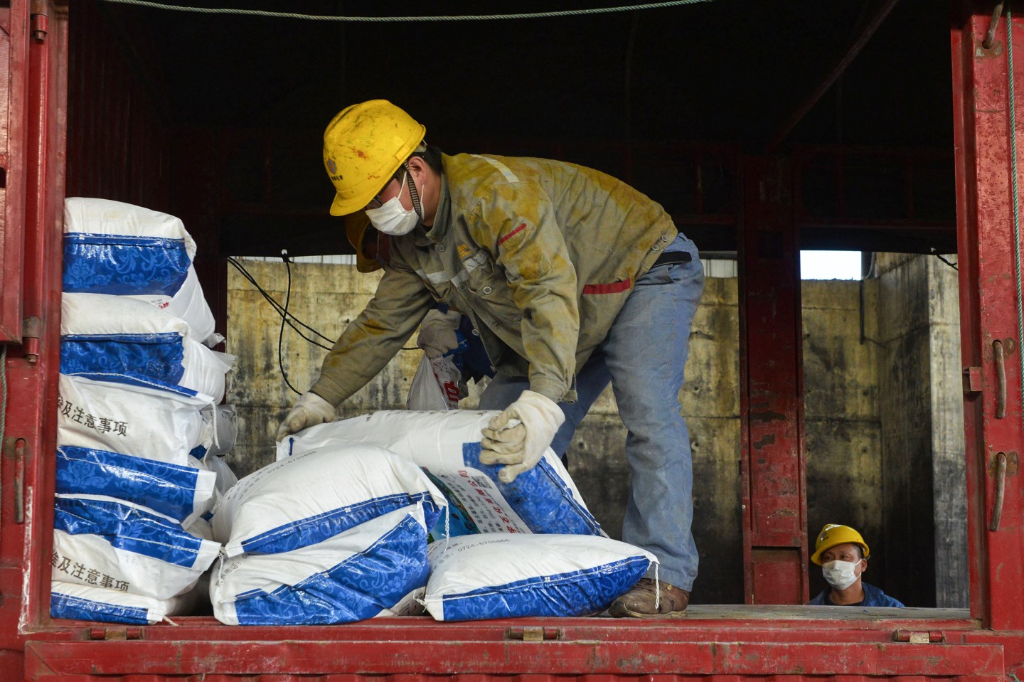 This photo taken on January 30, 2020 shows a worker transferring bags of disinfectant at a factory in Xiaogan in China's central Hubei province, to support the supply of medical materials during the virus outbreak in Hubei's city of Wuhan. - The nationwide death toll in China's coronavirus outbreak has risen to 213, with nearly 2,000 new cases confirmed, the National Health Commission said on January 31. (Photo by STR / AFP) / China OUT (Photo by STR/AFP via Getty Images)