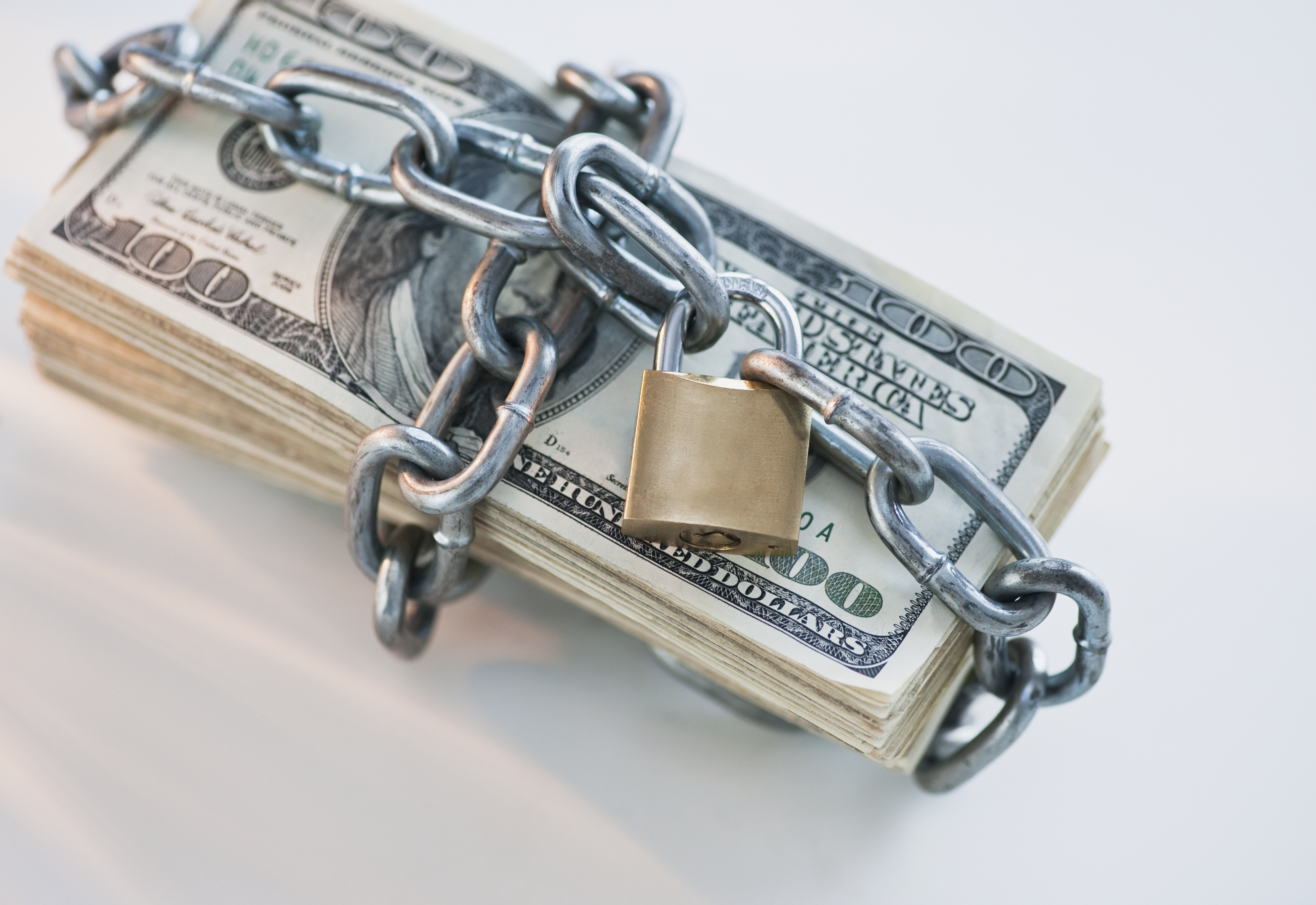 Money wrapped with lock and chain