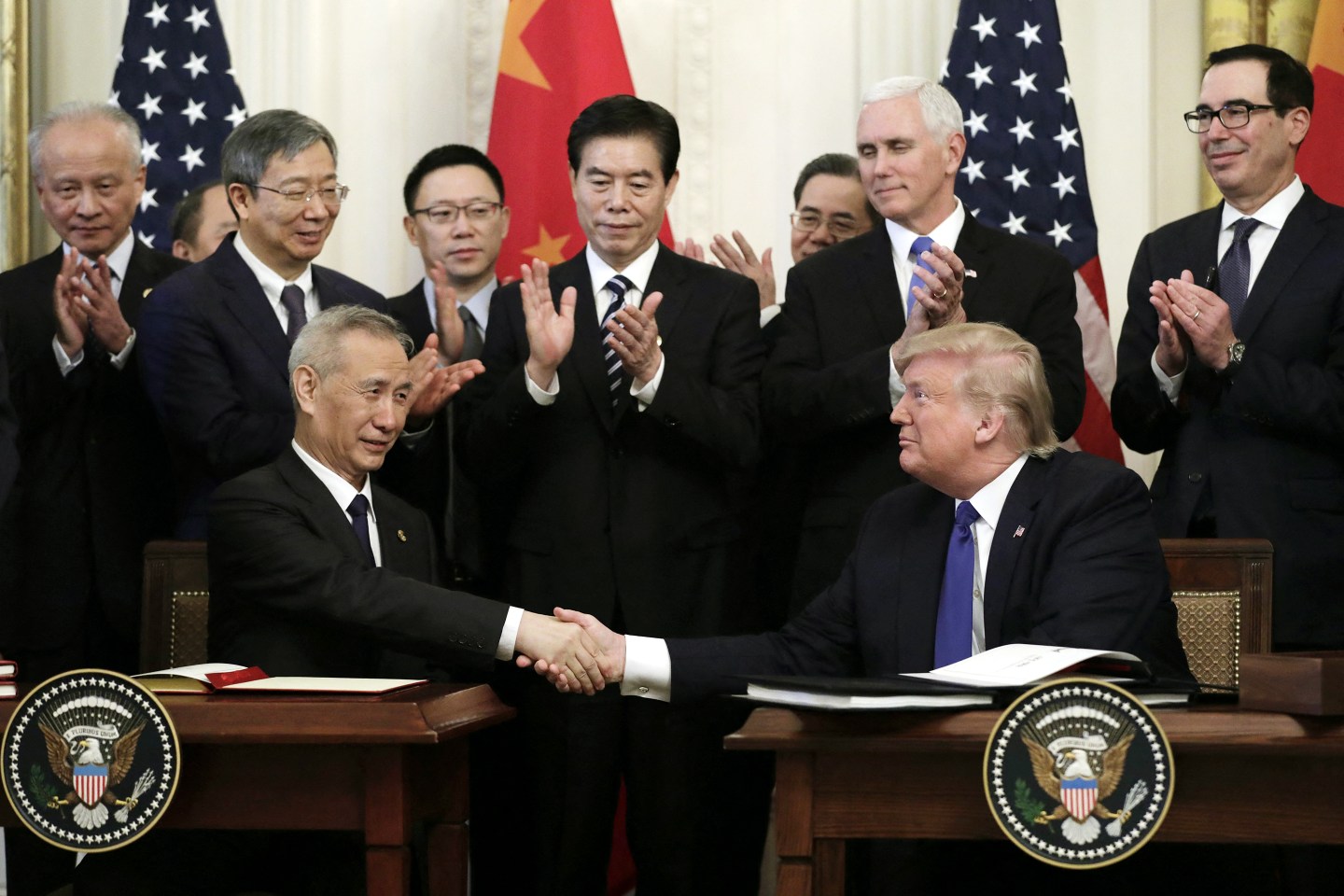 U.S. President Donald Trump and Chinese Vice Premier Liu He shake hands after signing a trade deal