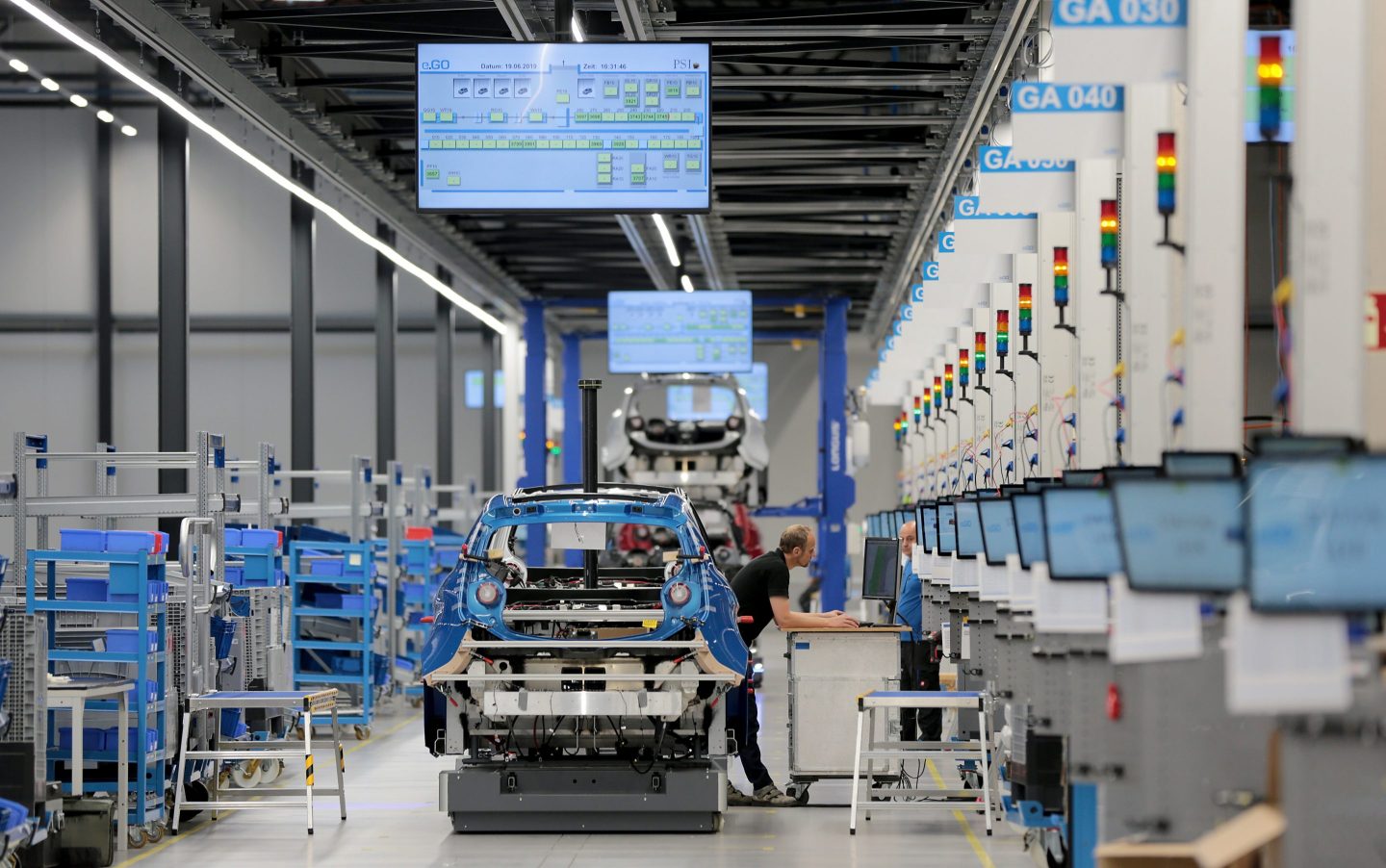 An employee of the electric car manufacturer e.Go works in the workshop on vehicle production.