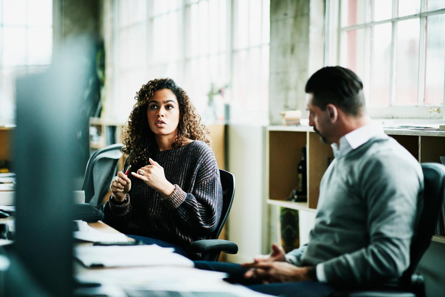 two employees talking in the workplace