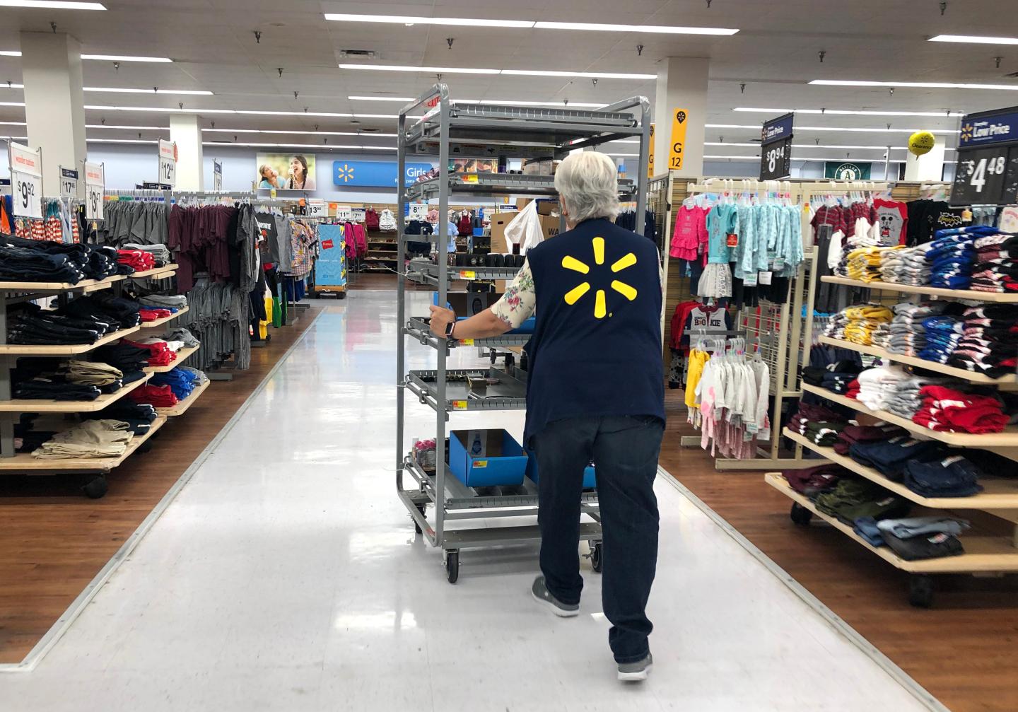 RICHMOND, CALIFORNIA - AUGUST 15: A Walmart employee pushes a cart through a Walmart store on August 15, 2019 in Richmond, California. Walmart beat analyst expectations with second quarter revenue of $130.4 billion. Shares of Walmart stock surged 5% in early trading on Thursday. (Photo by Justin Sullivan/Getty Images)