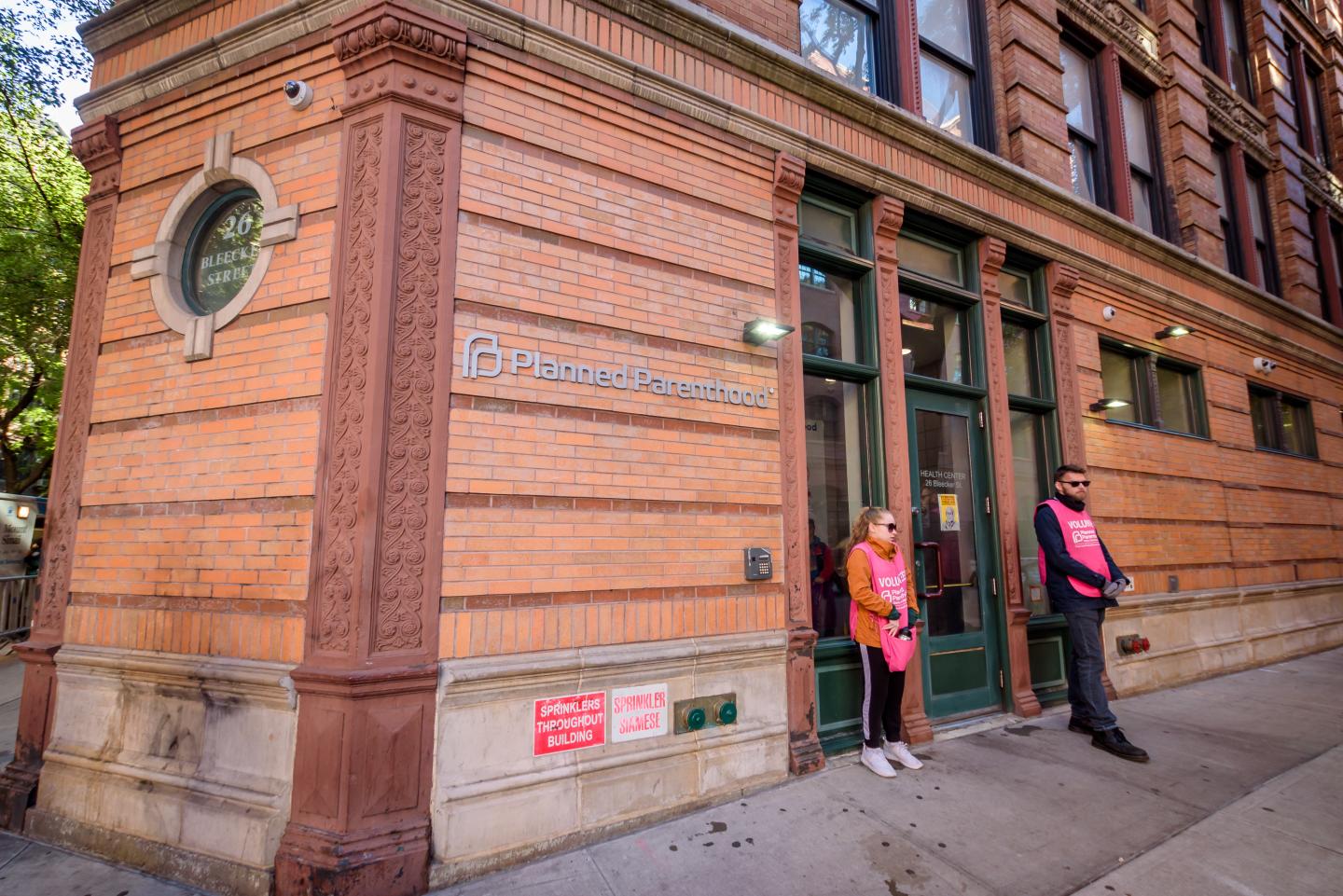 Two volunteers standing at the door of the Planned