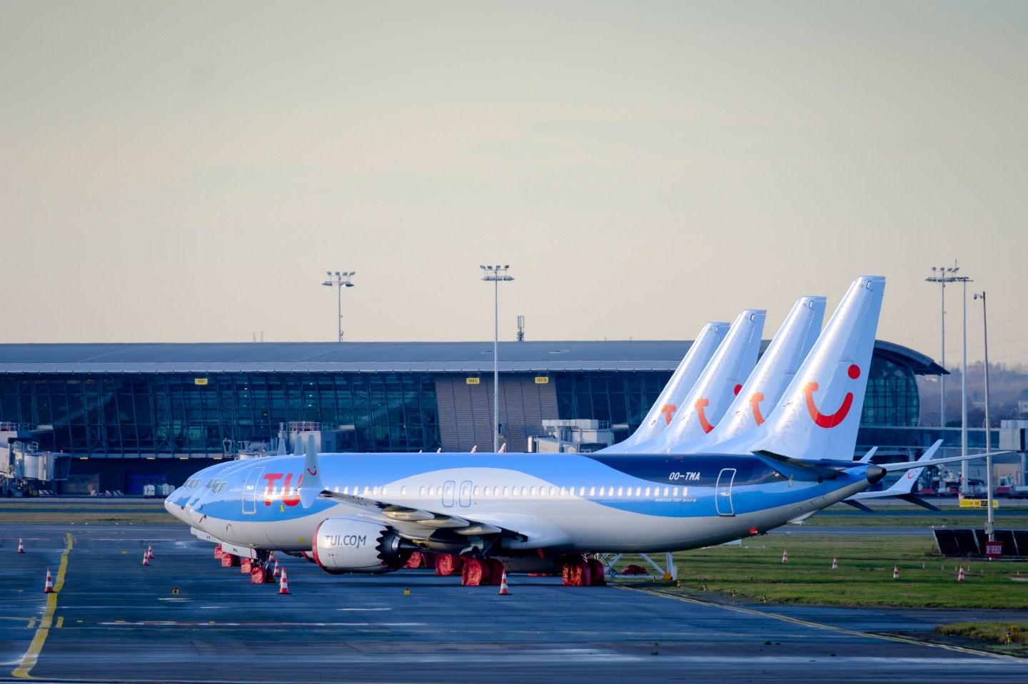 BRUSSELS, BELGIUM - DECEMBER 18: 4 Boeing 737 MAX from TUI fly Belgium are docked in Brussels on December 18, 2019. On December 16, 2019, Boeing announced: 'Safely returning the 737 MAX to service is our top priority. We know that the process of approving the 737 MAX's return to service, and of determining appropriate training requirements, must be extraordinarily thorough and robust, to ensure that our regulators, customers, and the flying public have confidence in the 737 MAX updates. As we have previously said, the FAA and global regulatory authorities determine the timeline for certification and return to service. We remain fully committed to supporting this process. It is our duty to ensure that every requirement is fulfilled, and every question from our regulators answered. Throughout the grounding of the 737 MAX, Boeing has continued to build new airplanes and there are now approximately 400 airplanes in storage. We have previously stated that we would continually evaluate our production plans should the MAX grounding continue longer than we expected. As a result of this ongoing evaluation, we have decided to prioritize the delivery of stored aircraft and temporarily suspend production on the 737 program beginning next month.' Created in 2004 under the name of TUI Airlines Belgium, it took over, after the bankruptcy of Sobelair, which until then had been the main airline of the tour operator Jetair, to transport Belgian tourists to their destination. On October 19, 2016, Jetairfly and the other companies in the TUI group were renamed TUI Airlines to bring together the different brands of the group under the same name. (Photo by Thierry Monasse/Getty Images)