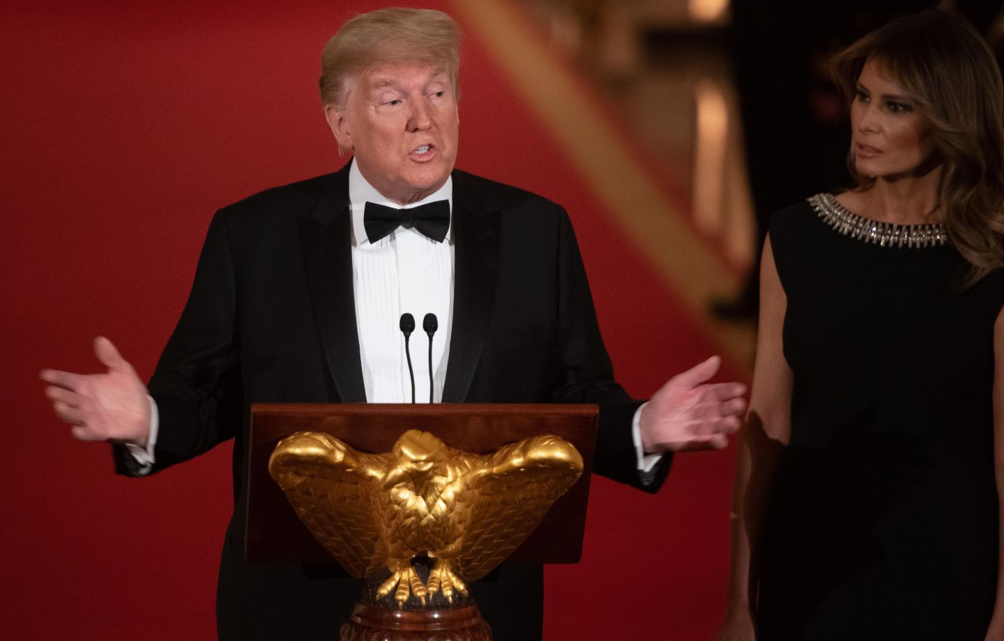 US President Donald Trump speaks alongside First Lady Melania Trump as they host the Governors' Ball in the East Room of the White House in Washington, DC, February 9, 2020.