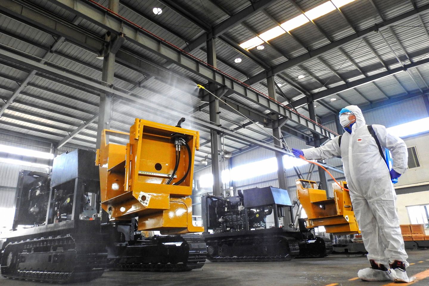 A worker disinfects machines before workers return to work from holidays at a factory in Lianyungang in China's eastern Jiangsu province, on Feb. 9, 2020.