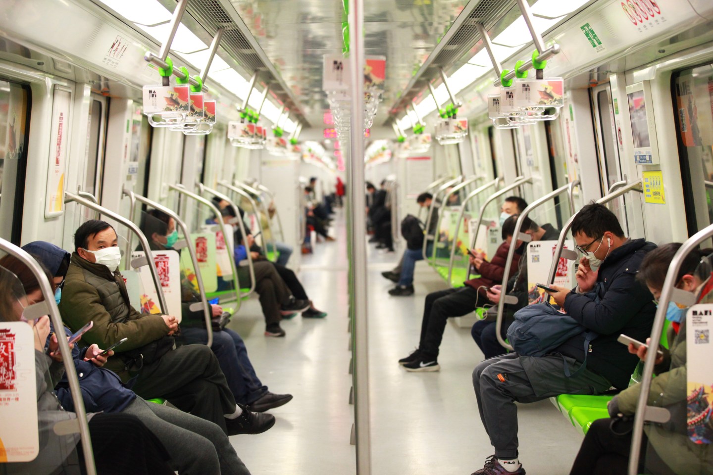 NANJING, CHINA - FEBRUARY 19 2020: Masked passengers ride a subway train in Nanjing in east China's Jiangsu province Wednesday, Feb. 19, 2020. Passengers are called upon to scan QR codes of every train carriages and buses on a mobile phone app so that when a new COVID-19 patient was found, those who shared the same rides could get alerted.- PHOTOGRAPH BY Feature China / Barcroft Media (Photo credit should read Feature China/Barcroft Media via Getty Images)