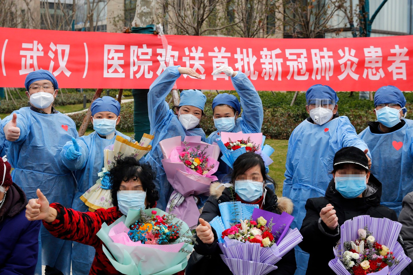 WUHAN, Feb. 19, 2020 -- Patients who recovered from novel coronavirus pneumonia pose for photos with medical staff in the Taikang Tongji Hospital in Wuhan, central China's Hubei Province, Feb. 19, 2020. A total of 13 patients infected with NCP recovered and were discharged on Wednesday in Taikang Tongji Hospital. (Photo by Shen Bohan/Xinhua via Getty Images)