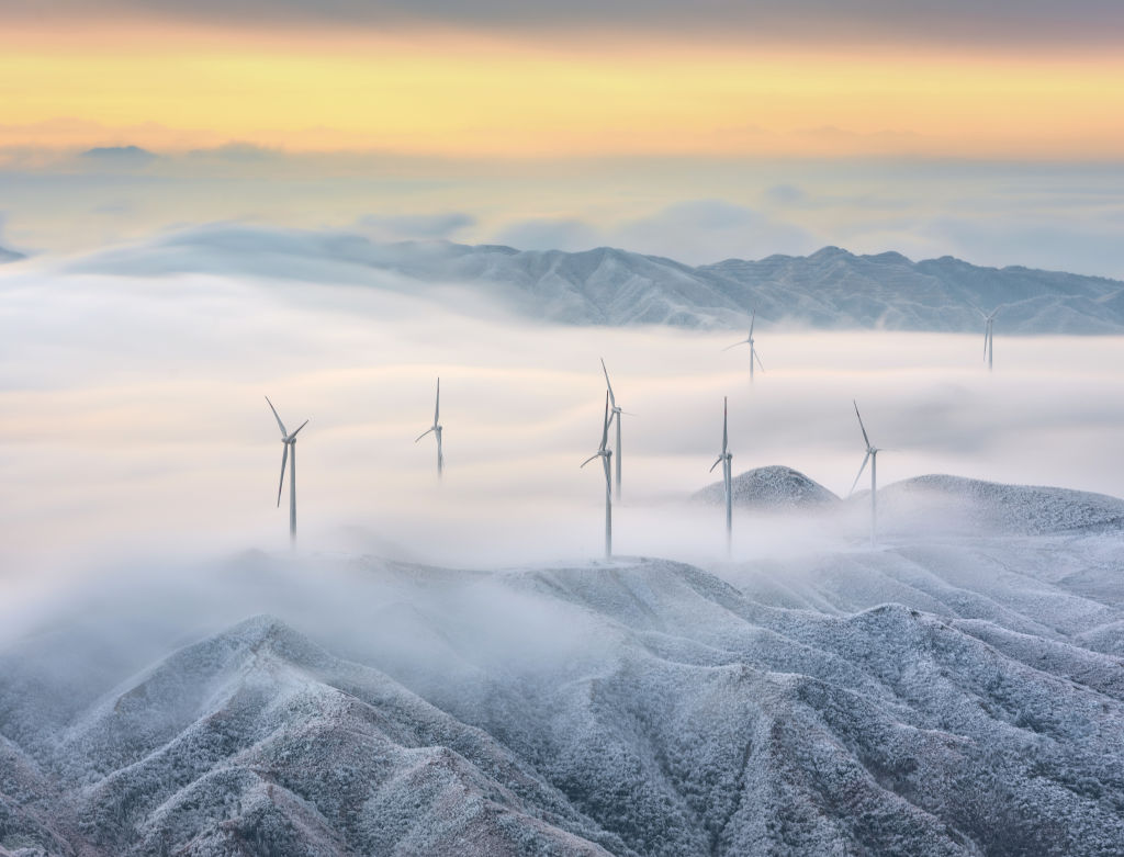 Wind turbines are seen at a wind farm after snow on January 27, 2020 in Guilin, Guangxi Zhuang Autonomous Region of China. (Photo by Mo Qianwei/VCG via Getty Images)