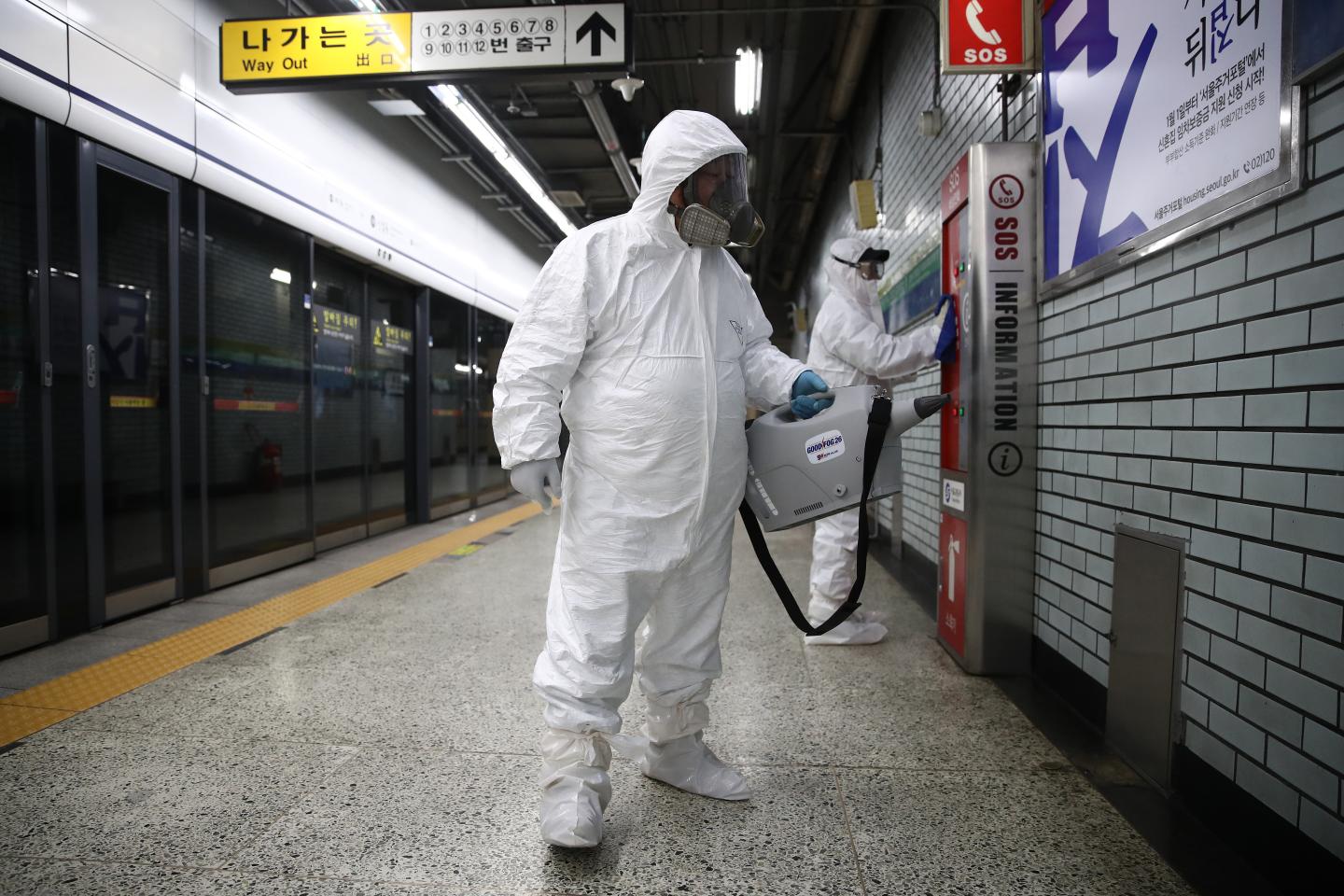 Disinfection workers wearing protective gears spray anti-septic solution against the coronavirus (COVID-19) at the subway station on February 21, 2020 in Seoul, South Korea. South Korea reported 52 new cases of the coronavirus (COVID-19) bringing the total number of infections in the nation to 156, with the potentially fatal illness spreading fast across the country.