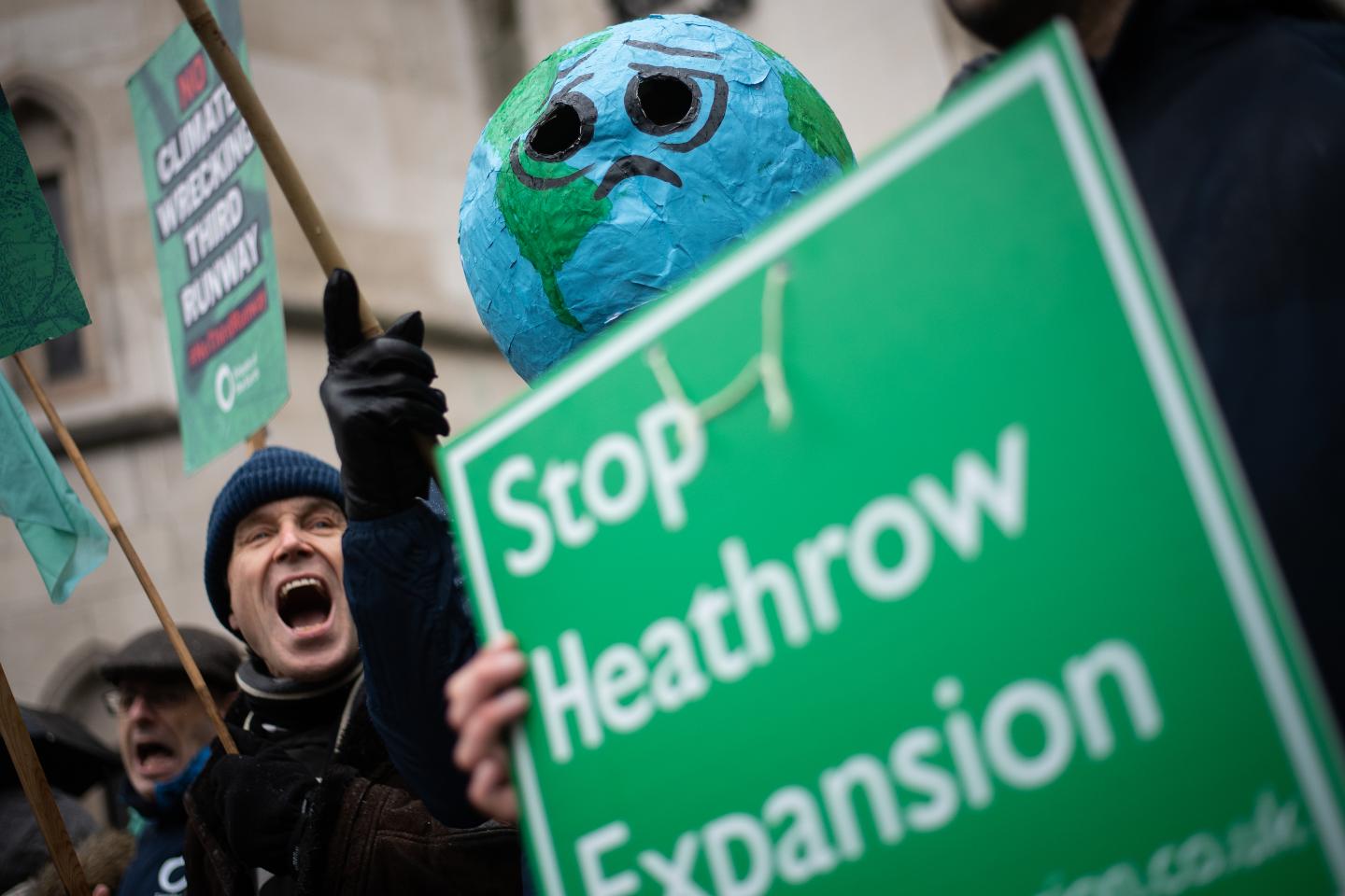 LONDON, ENGLAND - FEBRUARY 27: Environmental campaigners protest outside the Royal Courts of Justice ahead of the announcement of the ruling on the controversial third runway for Heathrow airport on February 27, 2020 in London, England. Critics of the plans took the case to the court of appeal, claiming that the developments did not take into account climate change commitments. (Photo by Leon Neal/Getty Images)
