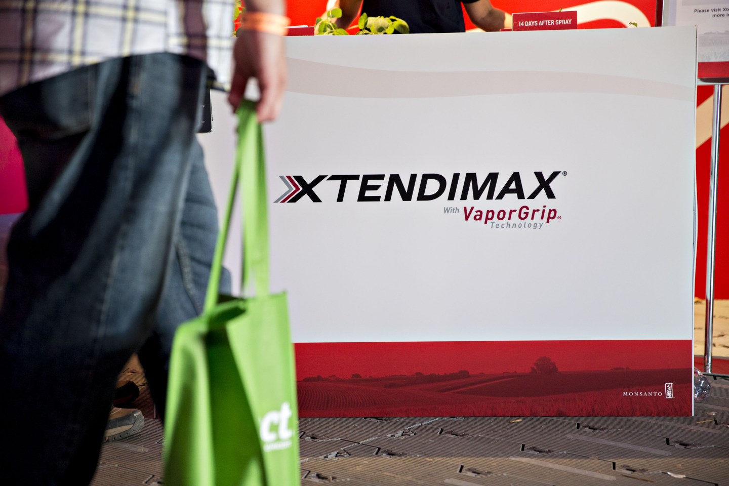 A sign for Monsanto Co. Xtendimax herbicide, a dicamba product developed to combat "superweeds" resistant to RoundUp glyphosate herbicide, hangs in the Monsanto booth during the Farm Progress Show in Decatur, Illinois, U.S., on Tuesday, Aug. 29, 2017. The show, sponsored by Farm Progress Co. and owned by Penton Media, is billed as the largest outdoor farm show in the U.S. Photographer: Daniel Acker/Bloomberg via Getty Images