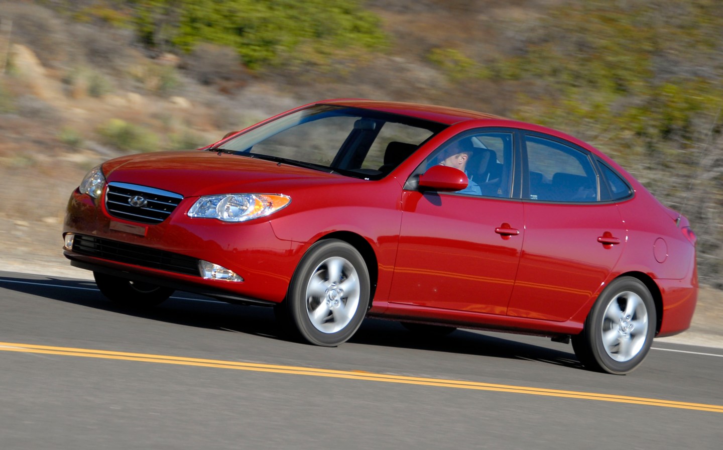 UNITED STATES - OCTOBER 26: Hyundai's 2007 Elantra Sedan is seen at speed on California's Pacific Coast Highway following the firm's introduction of the vehicle to the motoring press in California, on Thursday, October 26, 2006. The four-door, powered by a 138 horsepower 2-liter 4-cylinder engine, features six standard airbags, side-impact airbags, and roof-mounted side curtain airbags for front and outboard rear passengers. Hyundai estimates fuel economy at 28 city, 36 highway for both manual and automatic transmissions. (Photo by Mark Elias/Bloomberg via Getty Images)