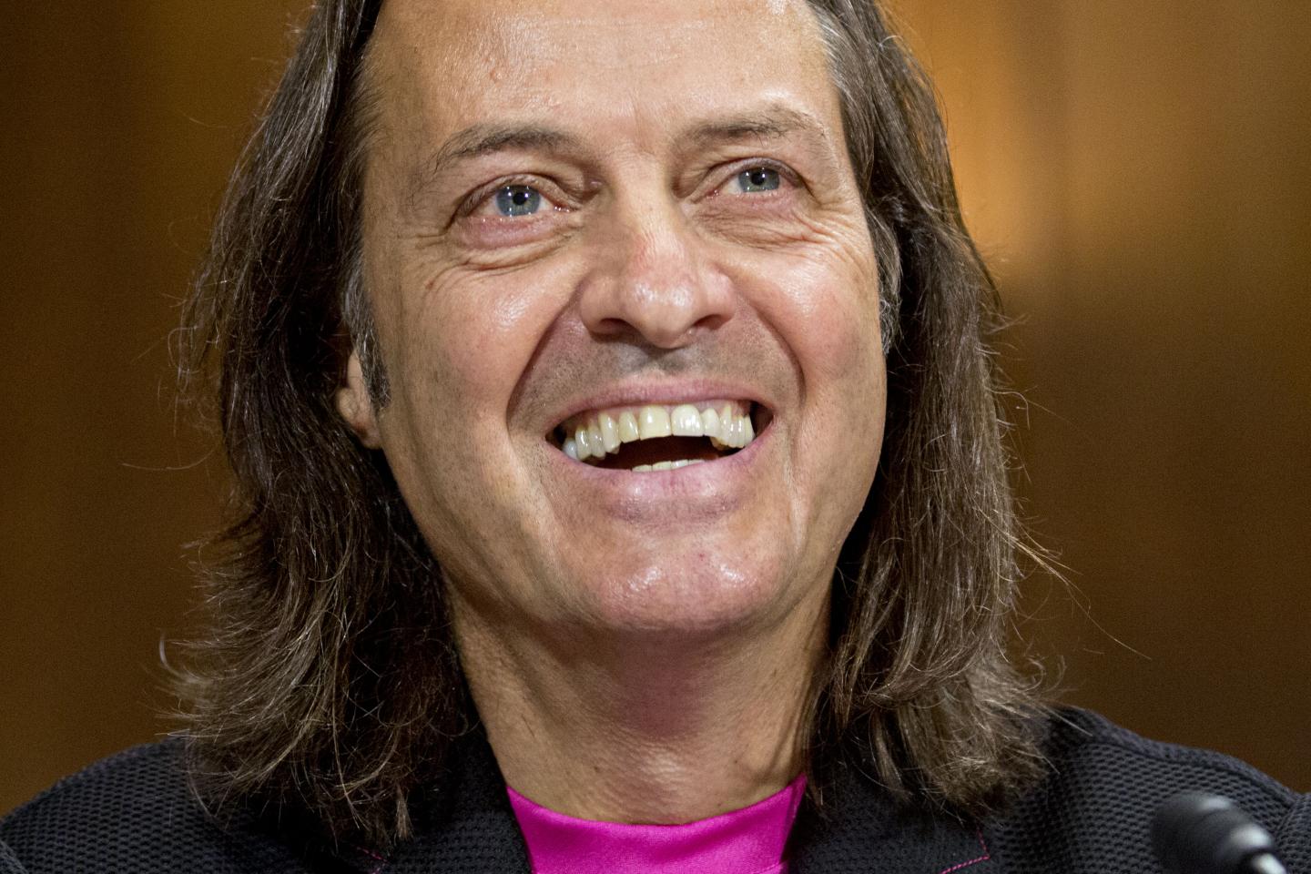 John Legere, chief executive officer of T-Mobile US Inc., smiles during a Senate Judiciary Subcommittee hearing on the impact of the T-Mobile and Sprint transaction in Washington, D.C., U.S., on Wednesday, June 27, 2018.