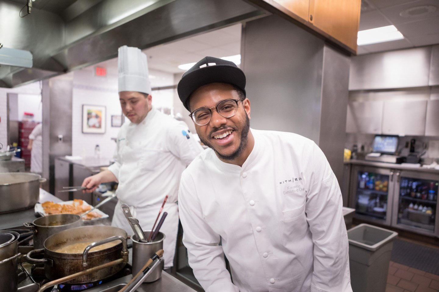 Kwame Onwuachi '13, working as a guest chef with students in the Bocuse Restaurant on The Culinary Institute of America's New York campus.
