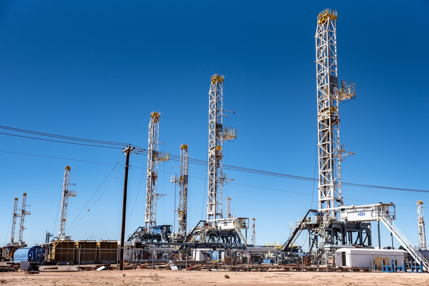 Oil rigs stand in the Permian Basin area of Odessa, Texas, on Jan. 19, 2019. In the Permian, America's busiest oil patch, a producer needs to blast as much as 60,000 barrels of water into a well every day, along with sand and chemicals, to complete the fracking that cracks open the tight, oil-bearing rock about a mile underground.