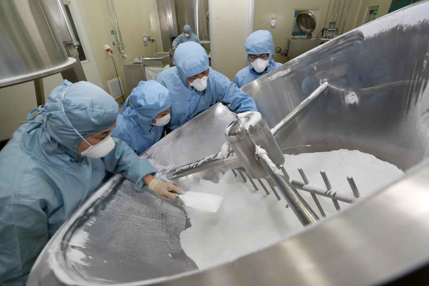 Employees work on the production line of chloroquine phosphate, an old drug for the treatment of malaria, in a pharmaceutical company in Nantong city in east China's Jiangsu province Feb. 27, 2020.