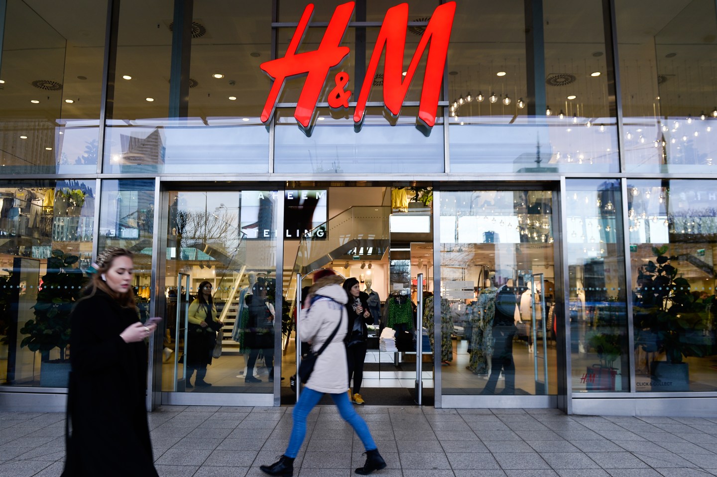 WARSAW, POLAND - 2020/03/03: People walk past a H&amp;M clothing store at the city center.