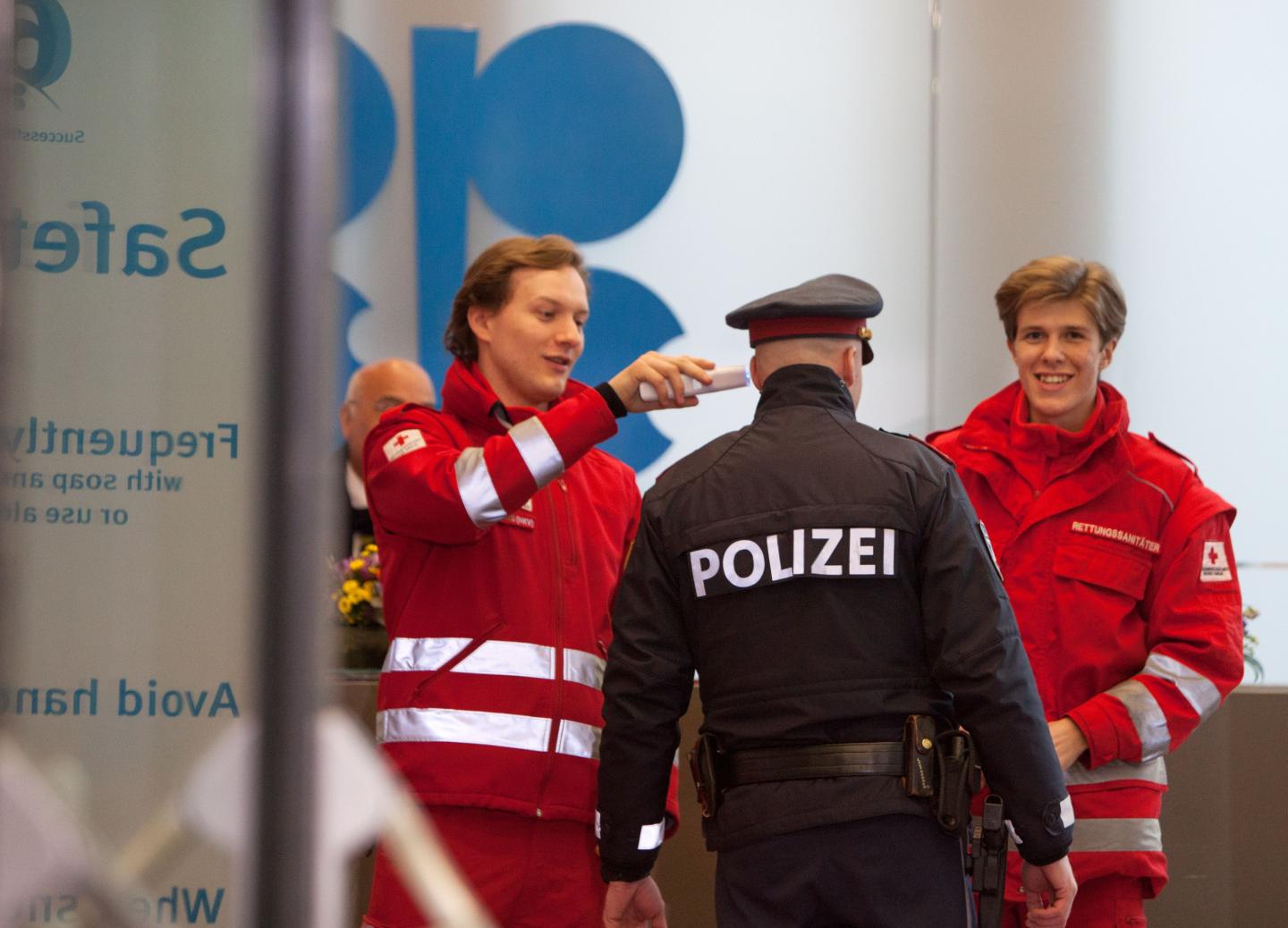 Red Cross medics check the temperature of a policeman during the 178th meeting of the Organization of Petroleum Exporting Countries (OPEC) in Vienna, Austria, on March 6, 2020. - All eyes are on Russia at the gathering of OPEC countries and their allies, with the cartel hoping to convince Moscow to back drastic production cuts to counter the effects of the coronavirus outbreak. (Photo by ALEX HALADA / AFP) (Photo by ALEX HALADA/AFP via Getty Images)