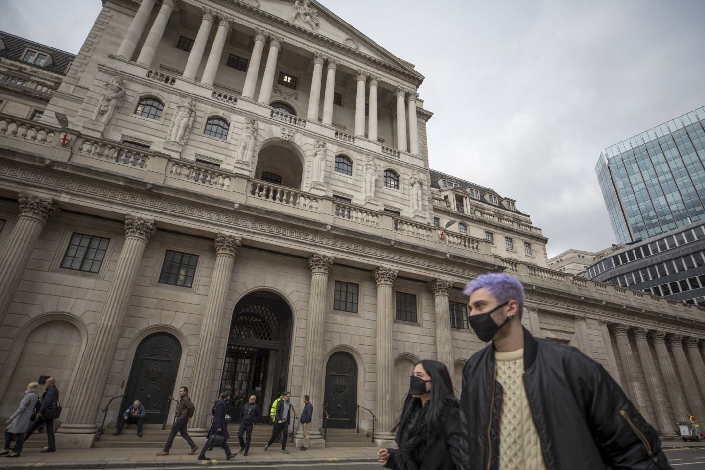 Masked pedestrians pass Bank of England