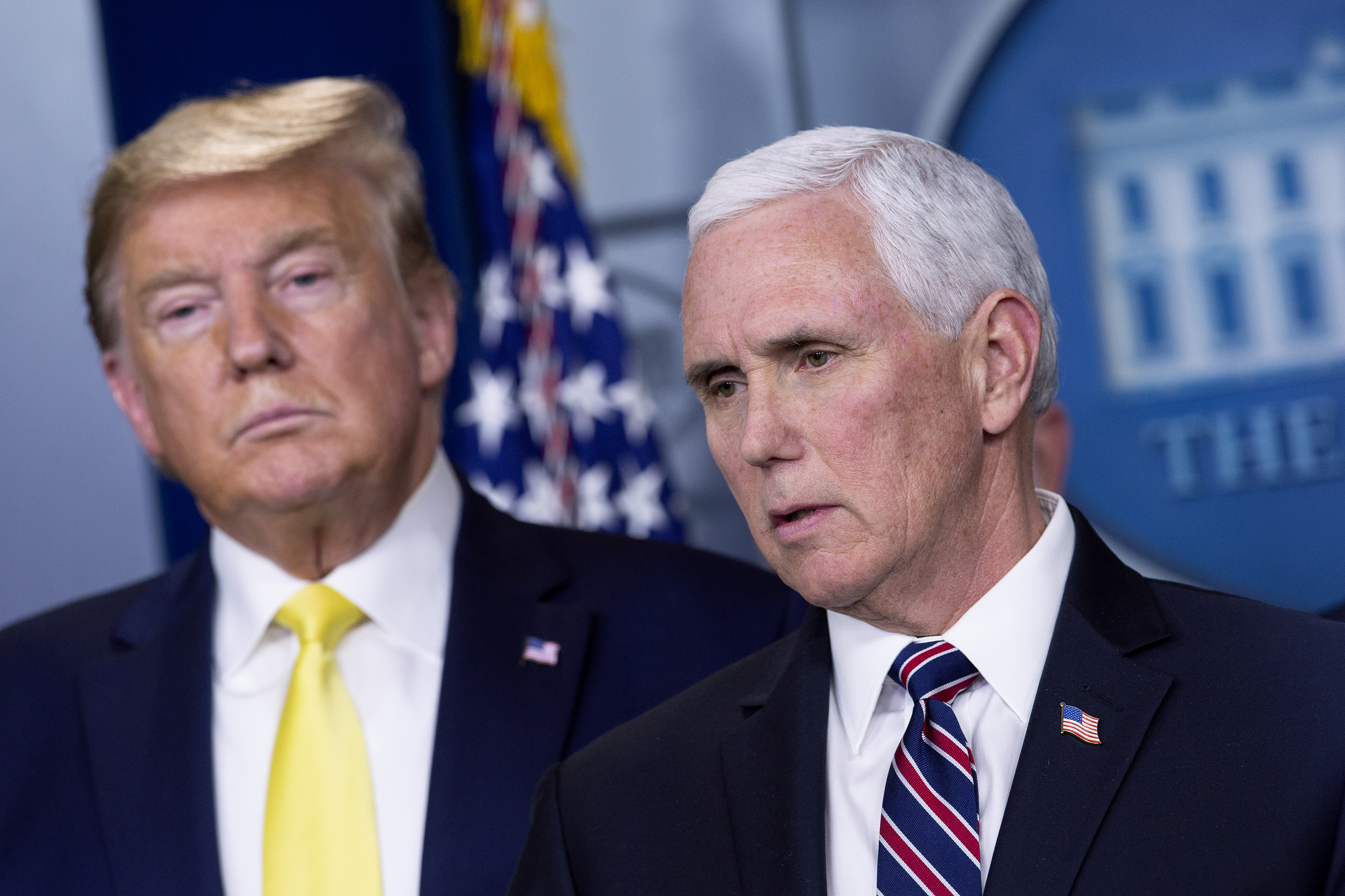 U.S. President Donald Trump, left, listens as Vice President Mike Pence speaks during a news conference in Washington, D.C., U.S., on Monday, March 9, 2020. Trump said Monday he will seek a payroll tax cut and "very substantial relief" for industries that have been hit by the virus, reversing course on the need for economic stimulus hours after markets posted their worst losses in more than a decade. Photographer: Stefani Reynolds/Bloomberg via Getty Images
