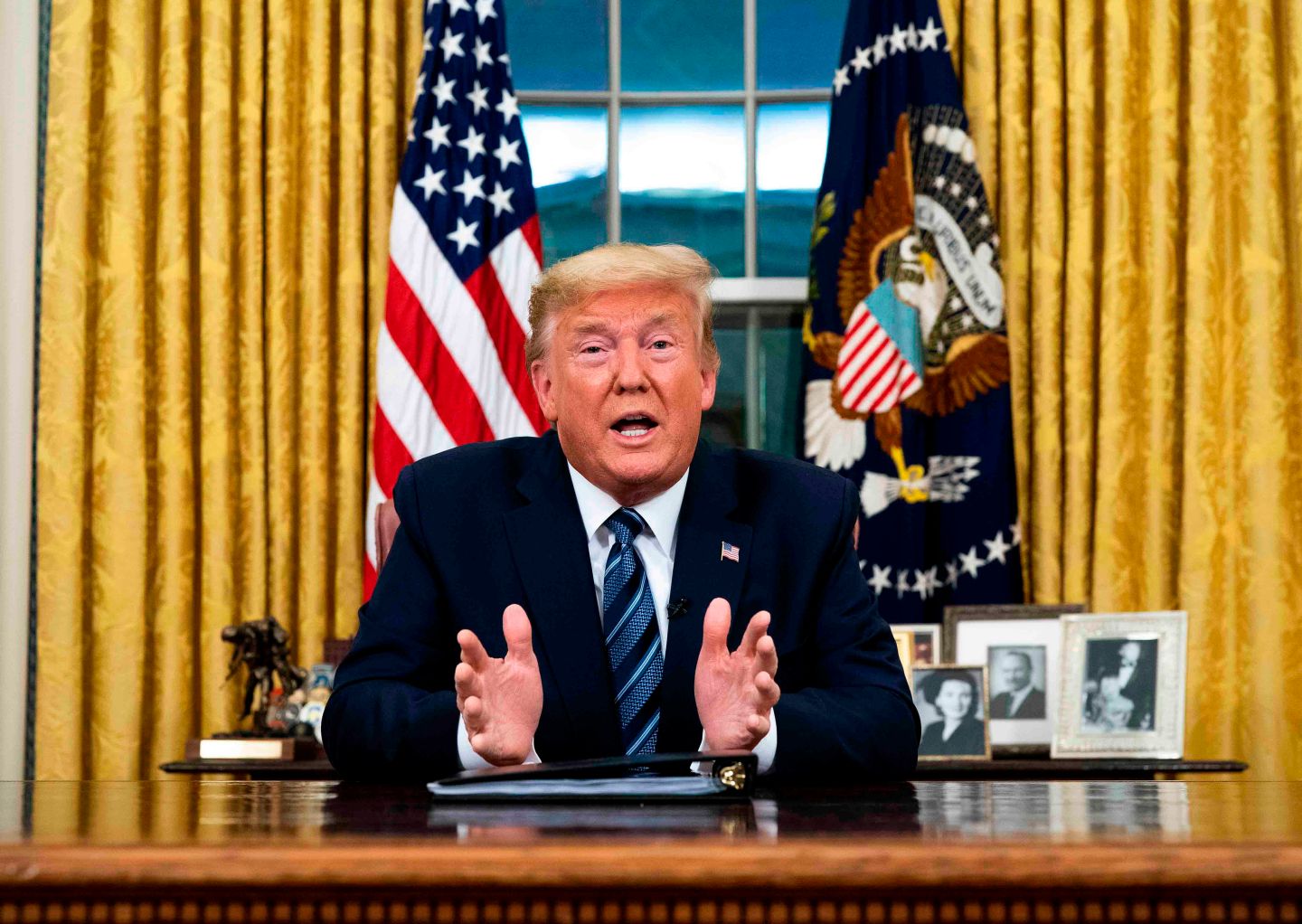 US President Donald Trump addresses the Nation from the Oval Office about the widening novel coronavirus (Covid-19) crisis in Washington, DC on March 11, 2020. - President Donald Trump announced on March 11, 2020 the United States would ban all travel from Europe for 30 days starting to stop the spread of the coronavirus outbreak. "To keep new cases from entering our shores, we will be suspending all travel from Europe to the United States for the next 30 days. The new rules will go into effect Friday at midnight," Trump said in an address to the nation. (Photo by Doug Mills / POOL / AFP) (Photo by DOUG MILLS/POOL/AFP via Getty Images)