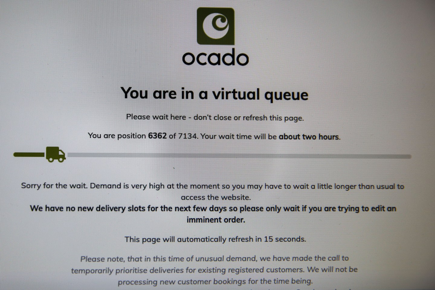 LONDON, UNITED KINGDOM - 2020/03/18: In this photo illustration, a screenshot of Ocado's website, showing over 7100 people waiting for online shopping with wait time of about two hours.
