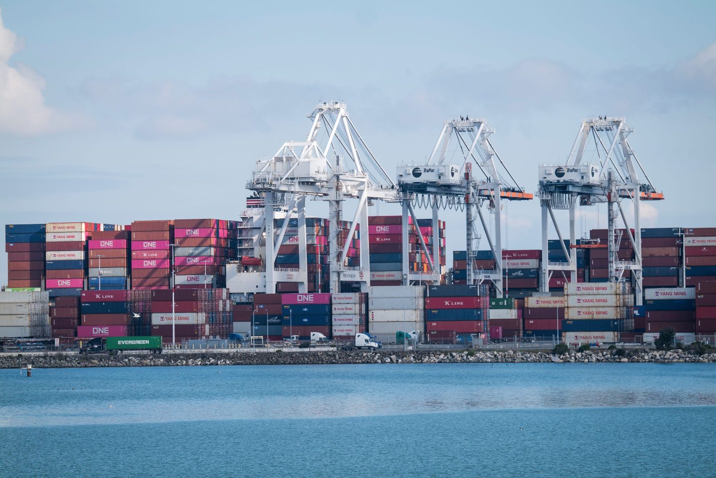 Shipping containers sit stacked at the Port of Oakland in Oakland, California, U.S., on Thursday, March 19, 2020.