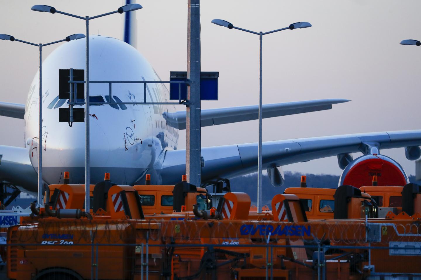 A passenger aircraft, operated by Deutsche Lufthansa AG, sits grounded on the closed north west runway at Frankfurt Airport, operated by Fraport AG, in Frankfurt, Germany, on Thursday, March 26, 2020. Unable to fill planes with passengers as the coronavirus destroys travel demand, airlines are instead using their fleets to transport more cargo, including medicines, smartphones and Korean strawberries. Photographer: Alex Kraus/Bloomberg via Getty Images